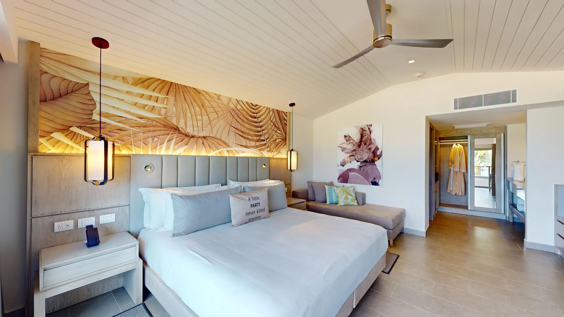 King bedroom with chaise lounge and open dressing area at Royalton CHIC Antigua.