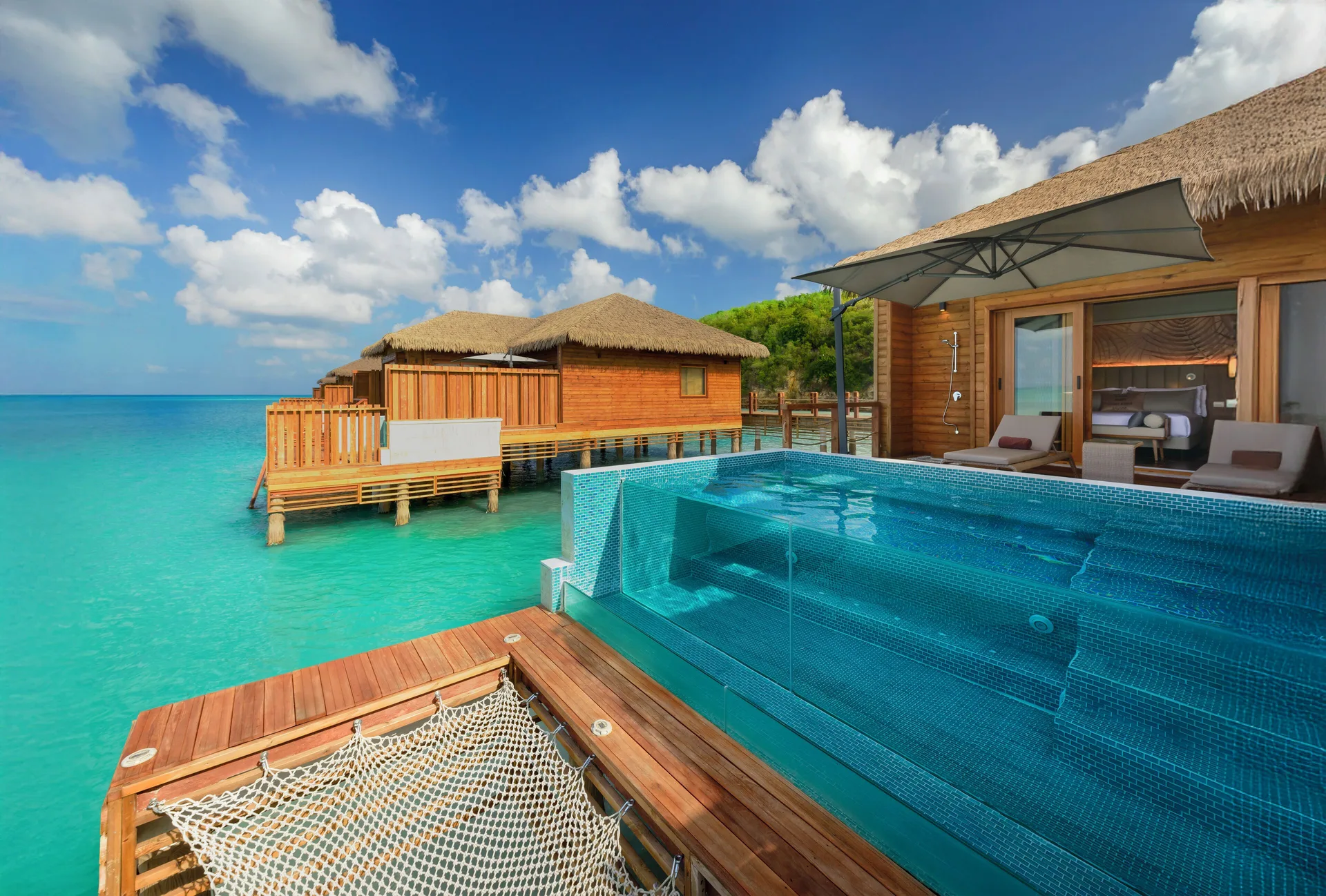 Overwater suite deck with plunge pool and ocean net at Royalton CHIC Antigua.