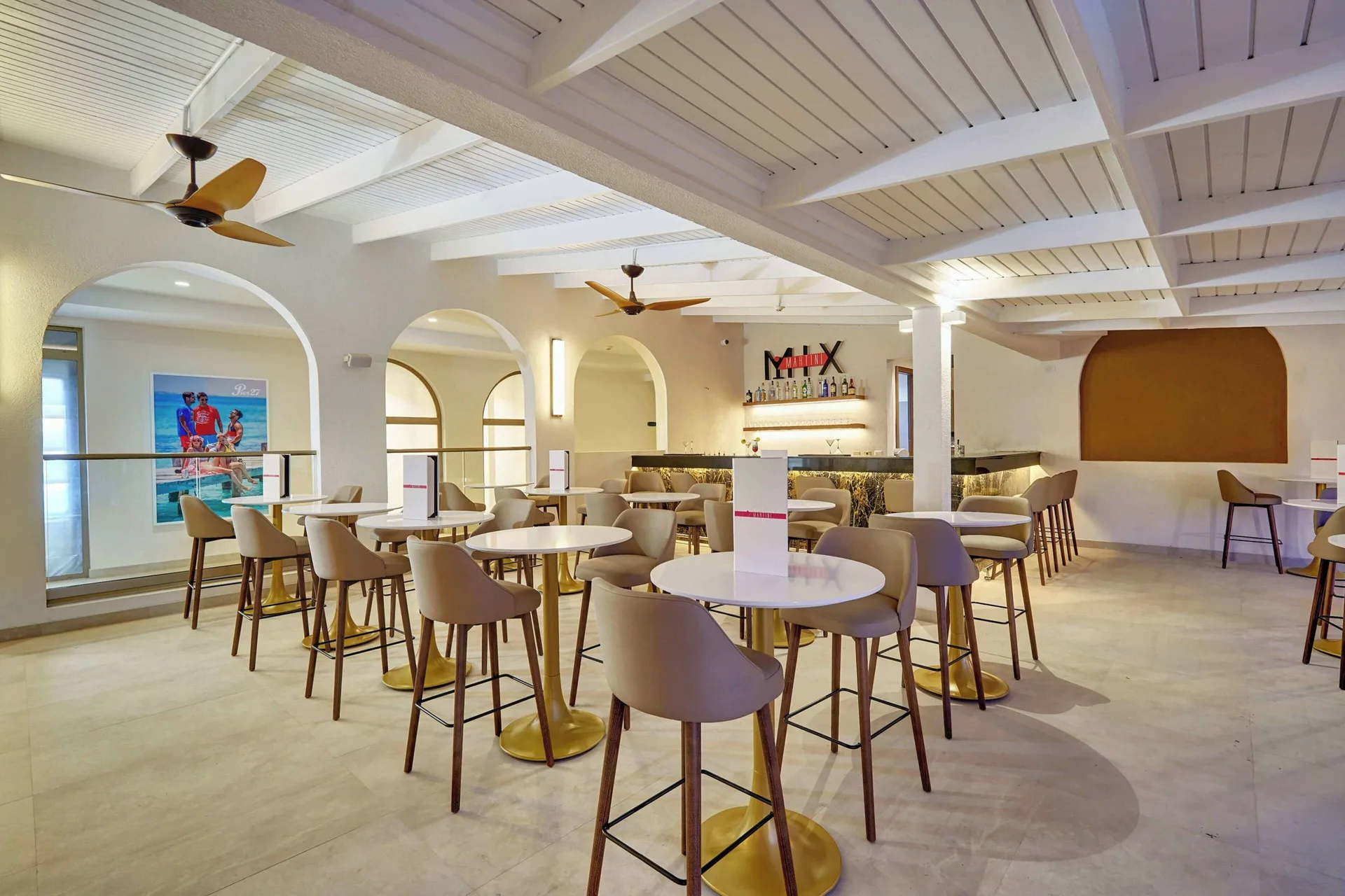 Martini Mix bar seating with round tables and high chairs at Royalton Grenada.