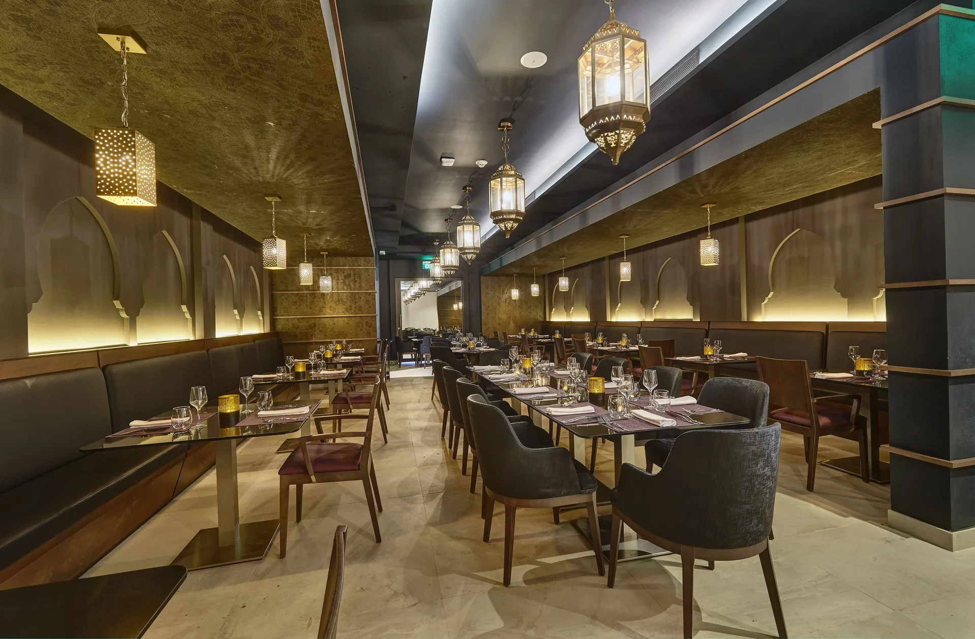 Elegant dining room with lantern lighting and arched wall details at Royalton Grenada.