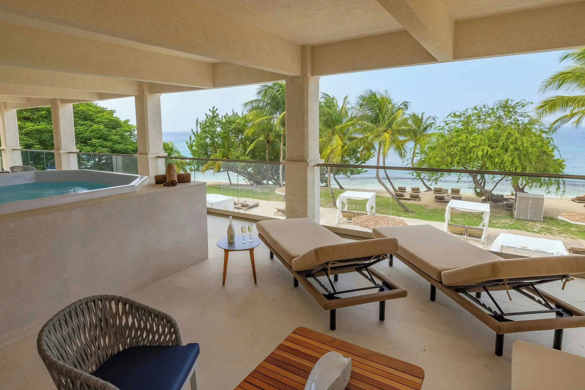 Chairman Two Bedroom Suite terrace with loungers, hot tub and ocean view at Royalton Grenada.