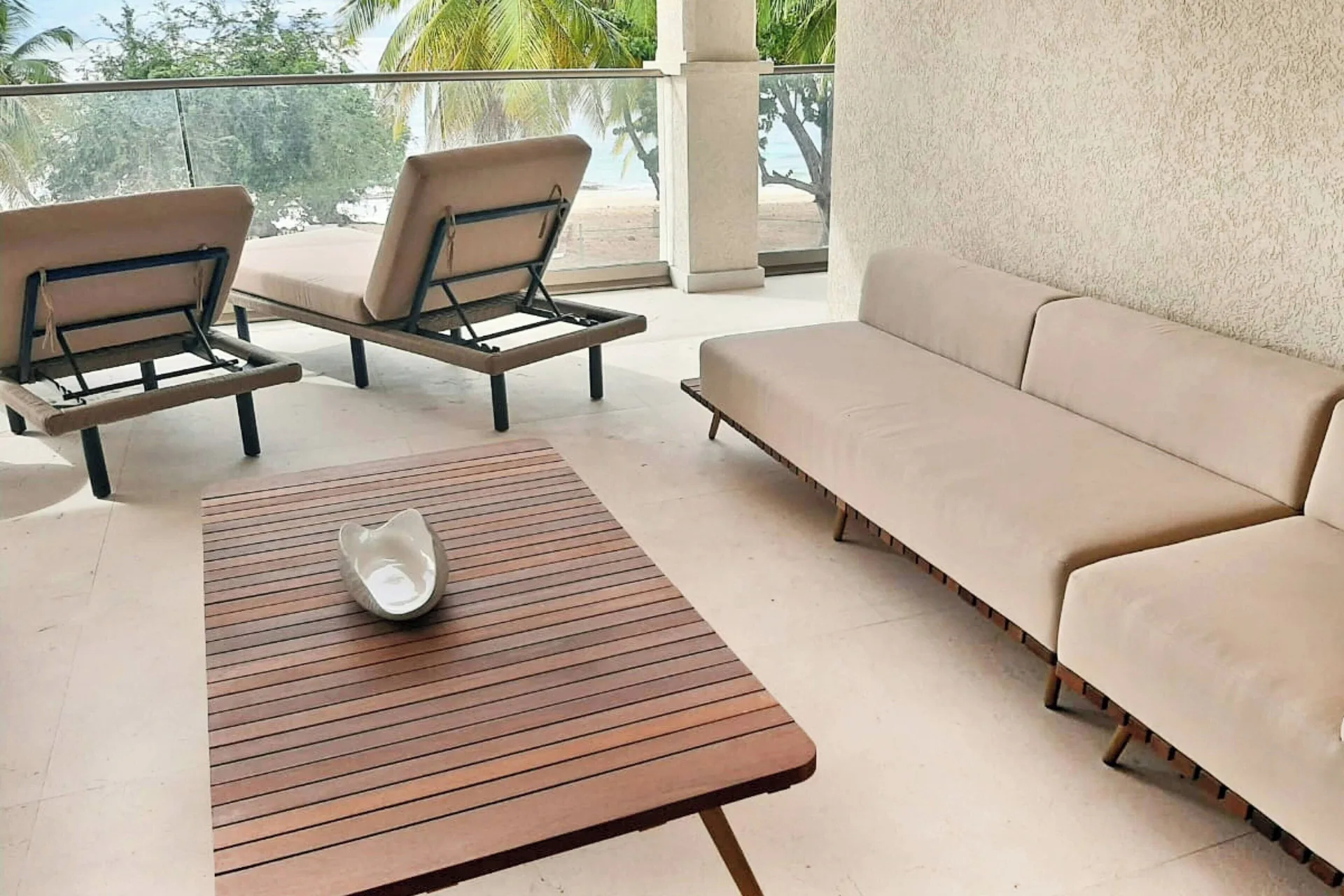 Oceanfront suite balcony lounge with chaise seating at Royalton Grenada.
