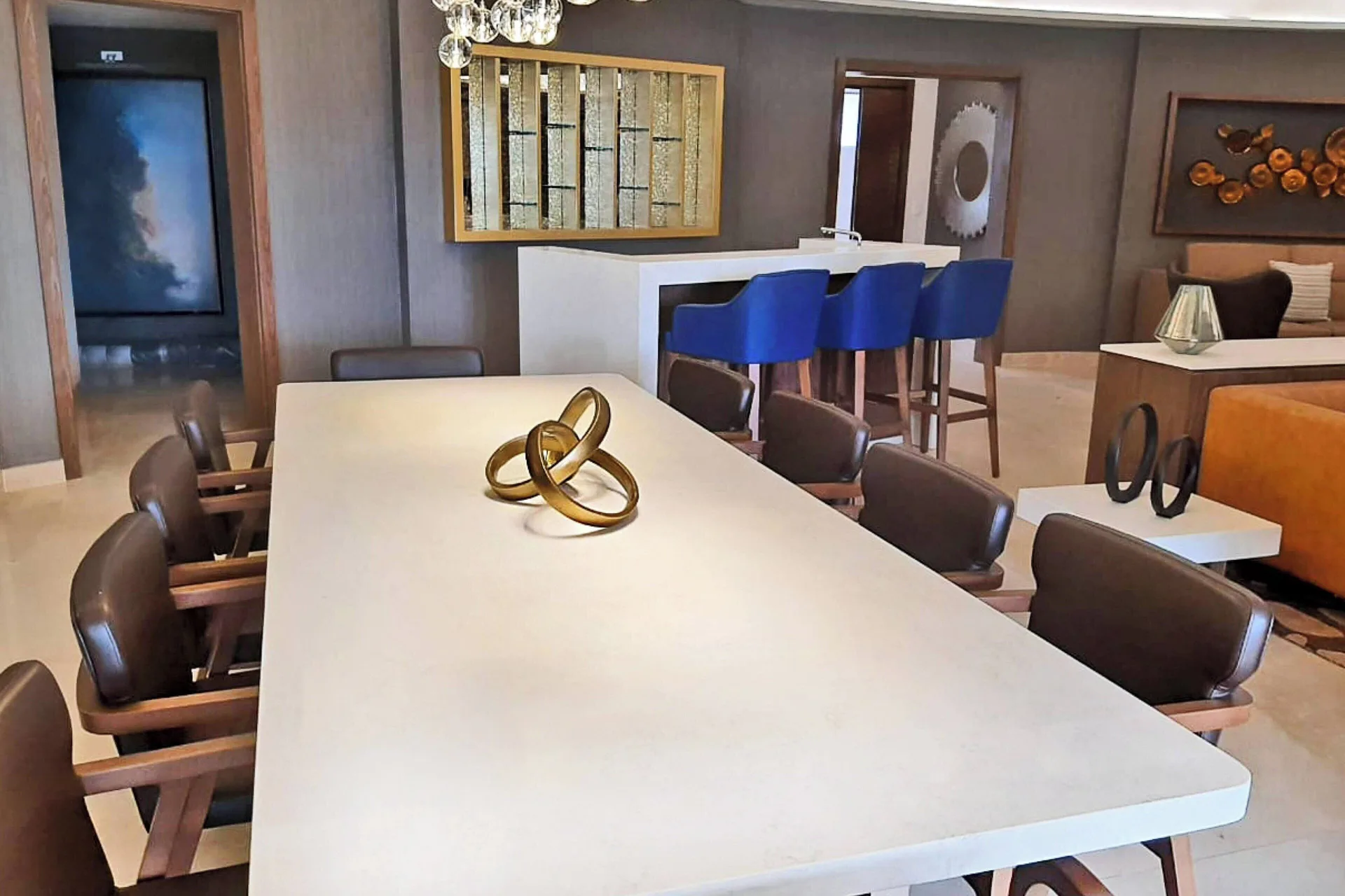 Suite dining area with long table and blue bar stools at Royalton Grenada.