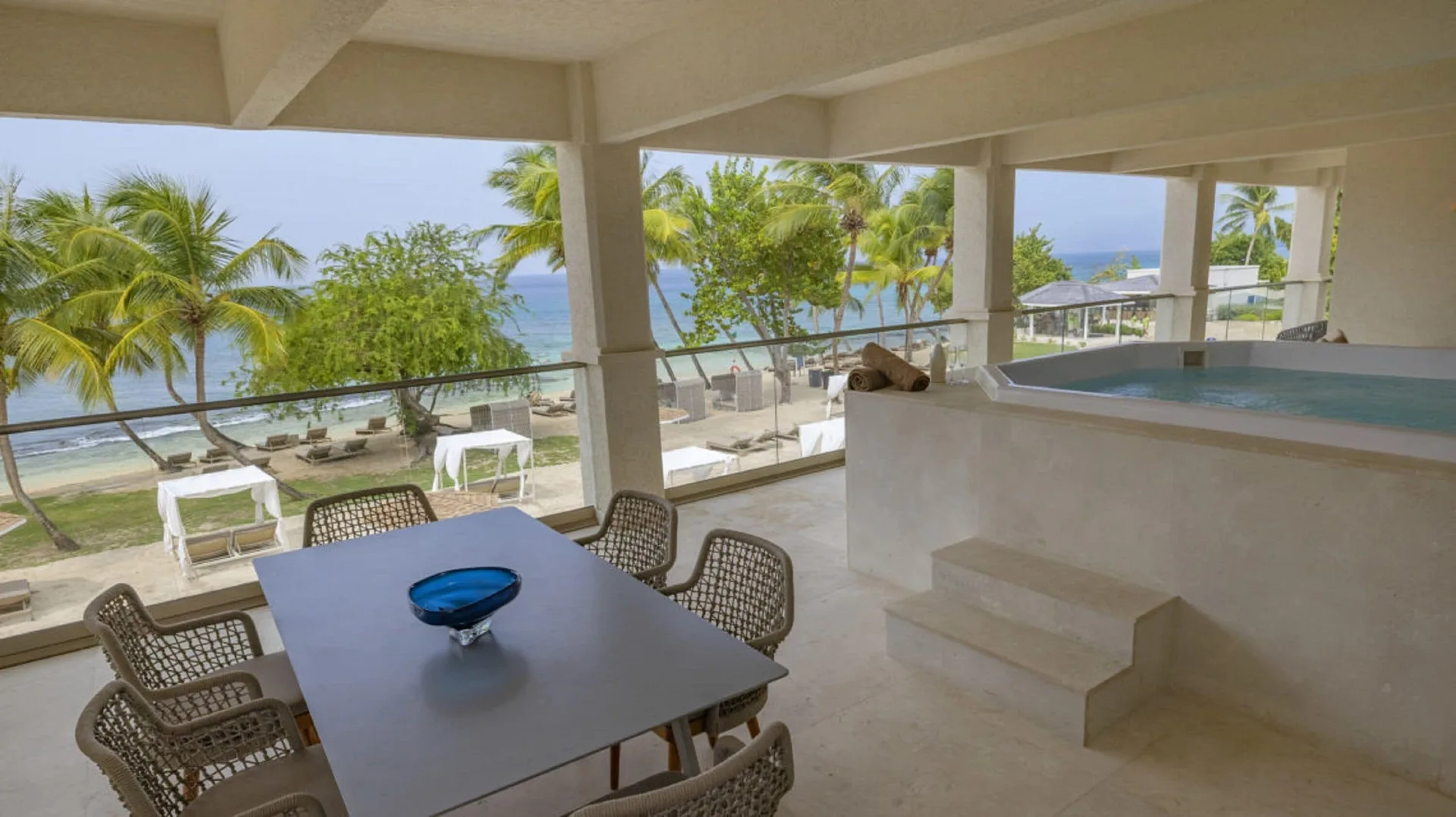 Oceanfront suite terrace with dining table and plunge pool at Royalton Grenada.