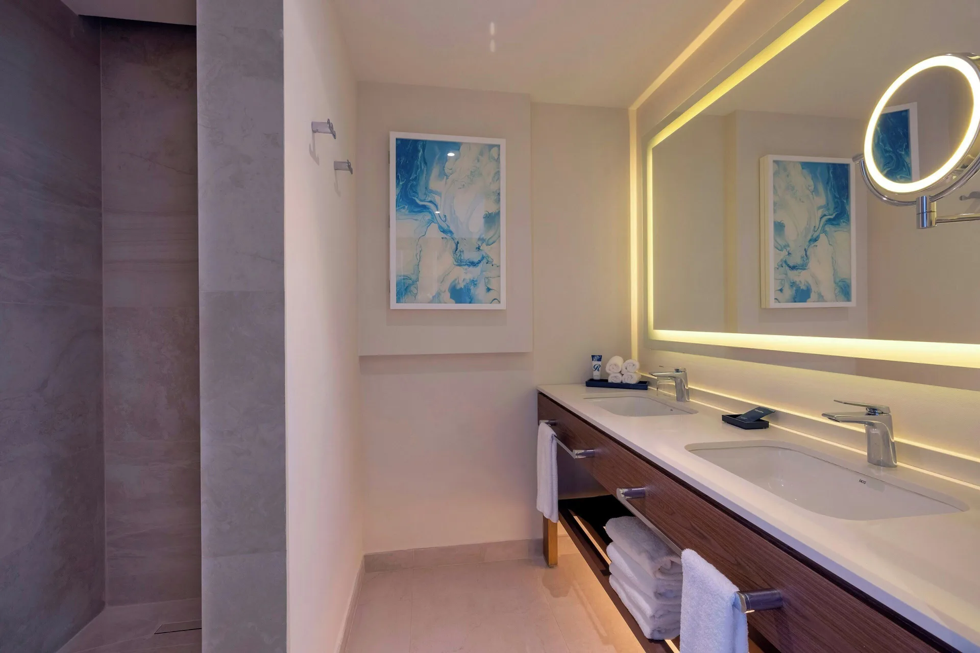 Bathroom vanity and walk-in shower in a Luxury Junior Suite Ocean Front Diamond Club at Royalton Grenada.