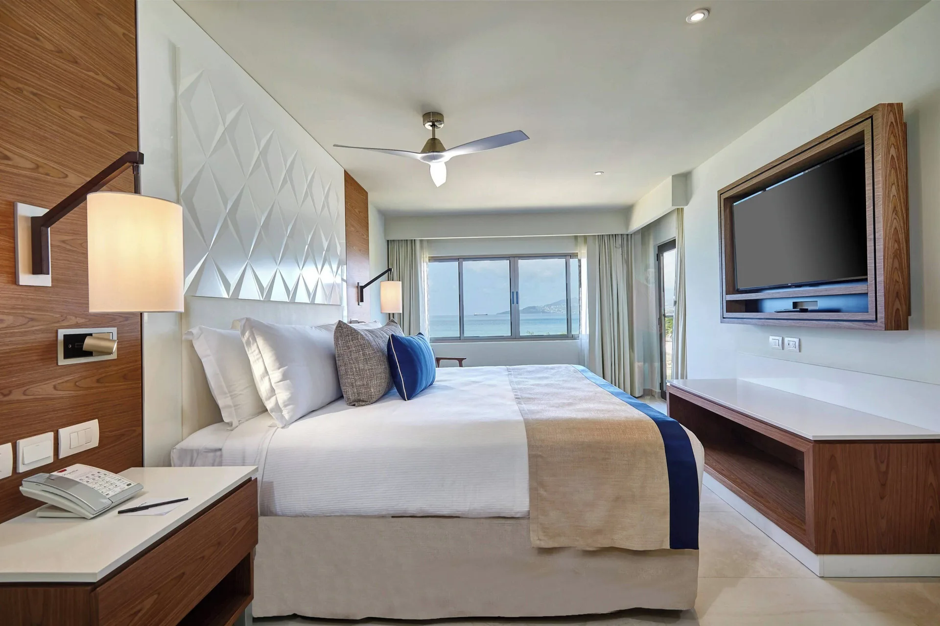 King bed and ocean view in a Luxury Junior Suite Ocean Front Diamond Club at Royalton Grenada.
