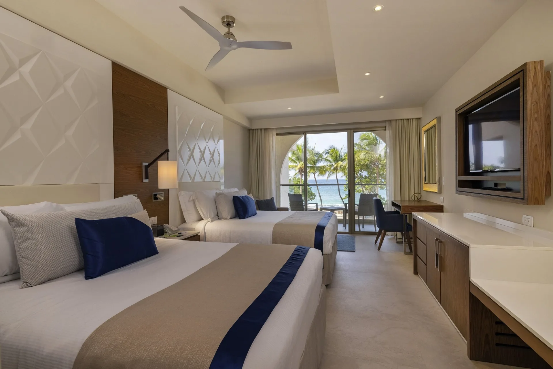 Luxury Room Beach Walkout Diamond Club with two beds and ocean-facing balcony at Royalton Grenada.