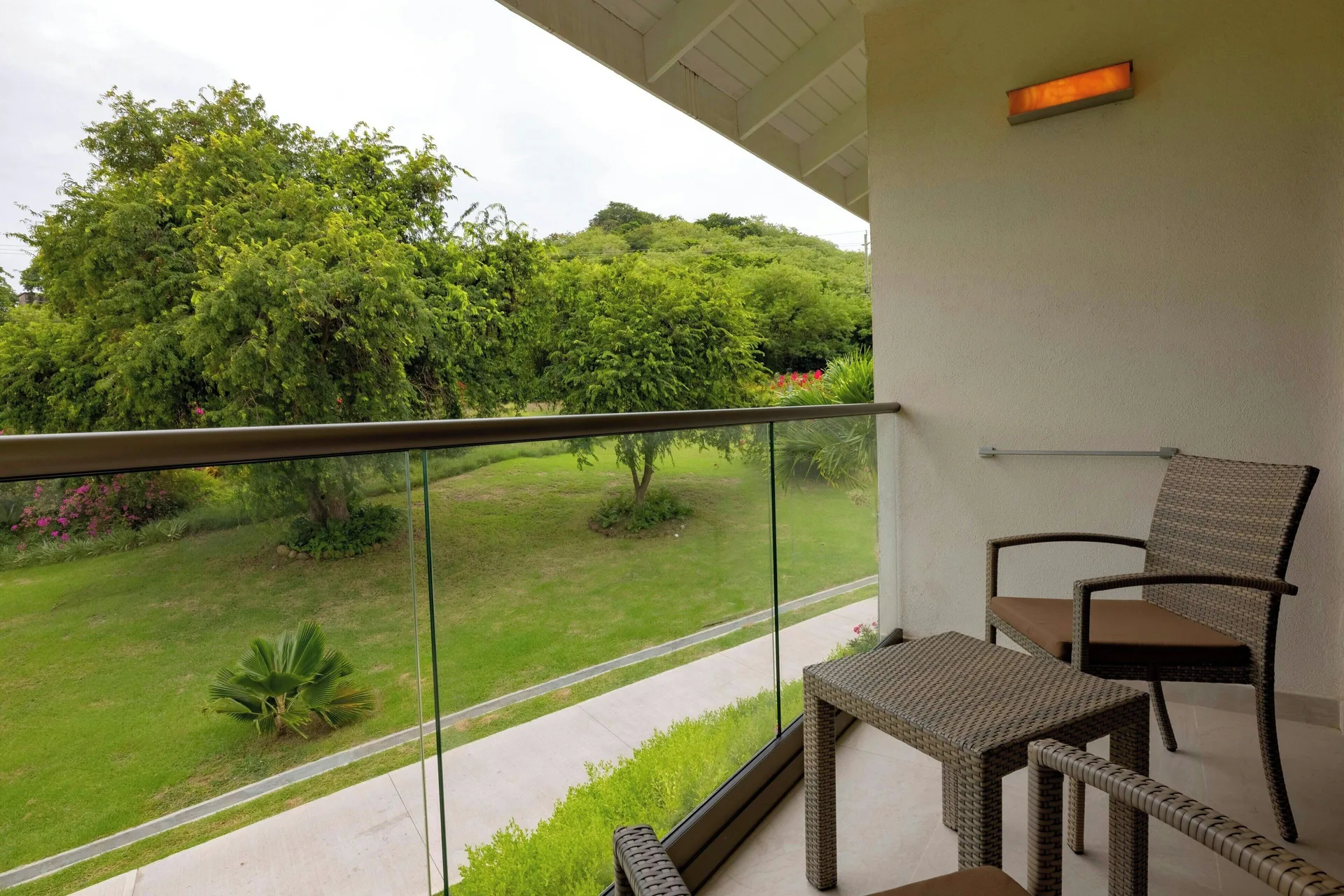 Luxury Room balcony with seating and garden view at Royalton Grenada.