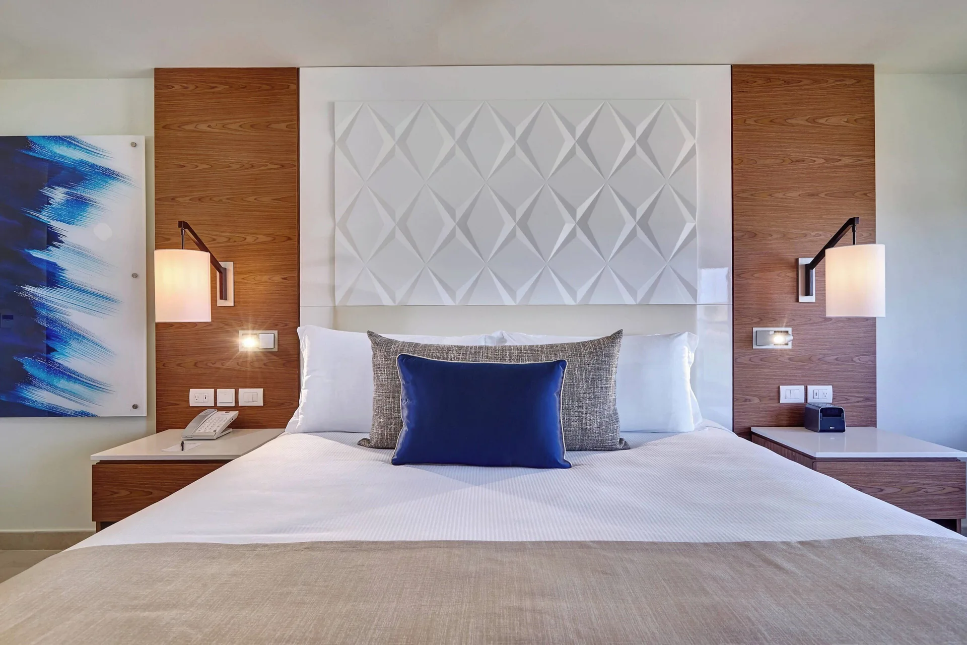 Luxury Room king bed with patterned headboard at Royalton Grenada.