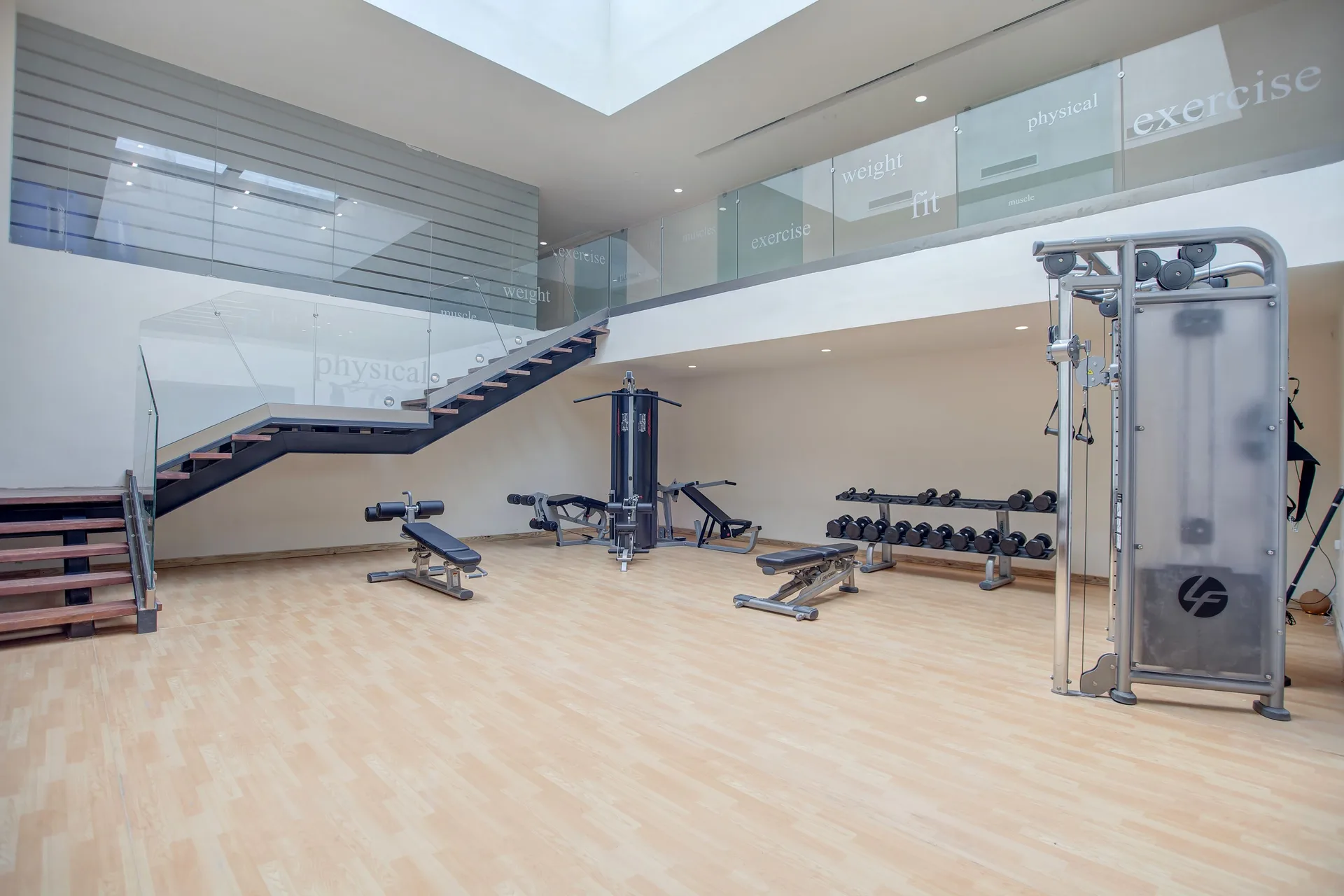 Spacious fitness center with weights and machines at Royalton Negril.