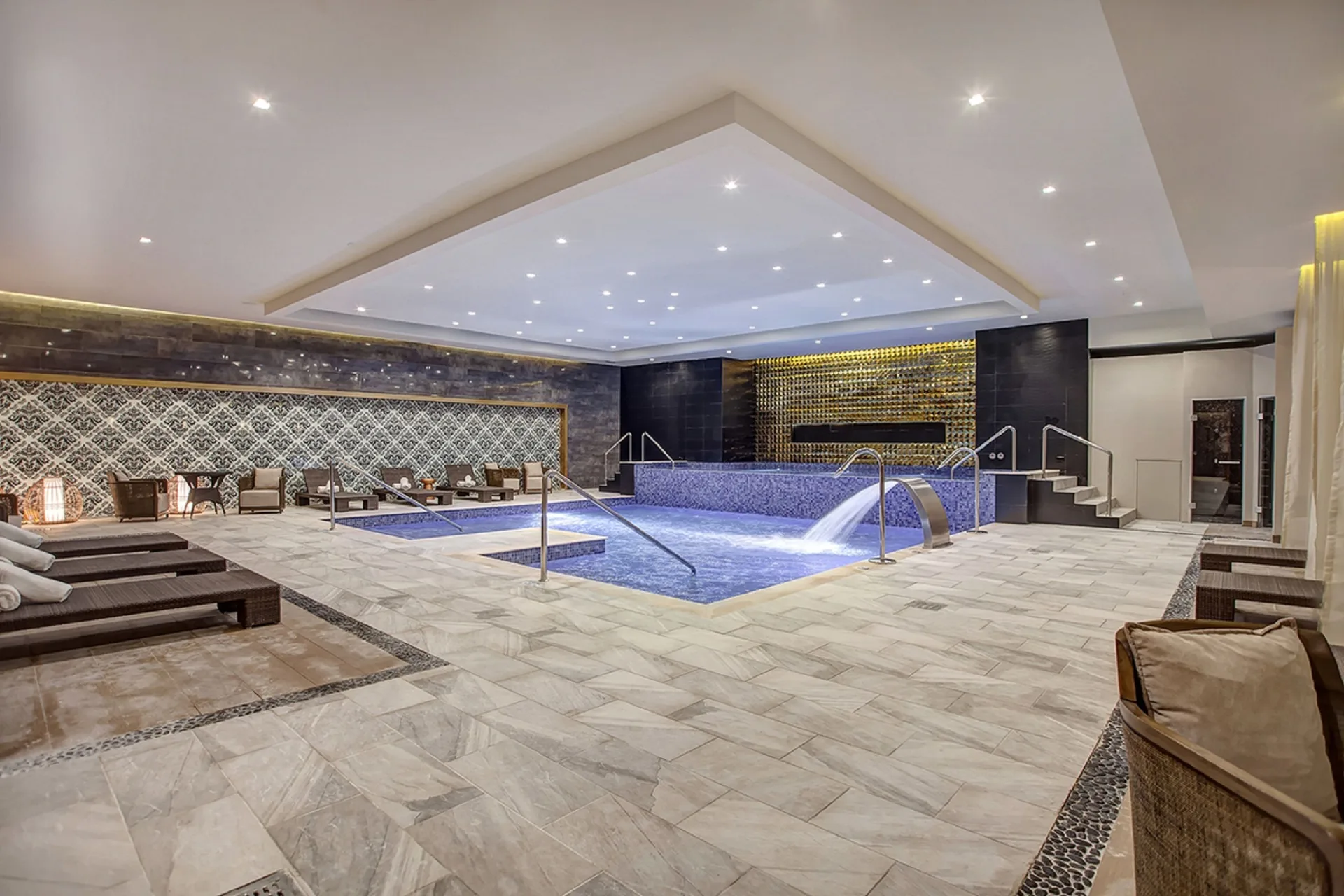 Indoor spa pool with loungers and water features at Royalton Negril.