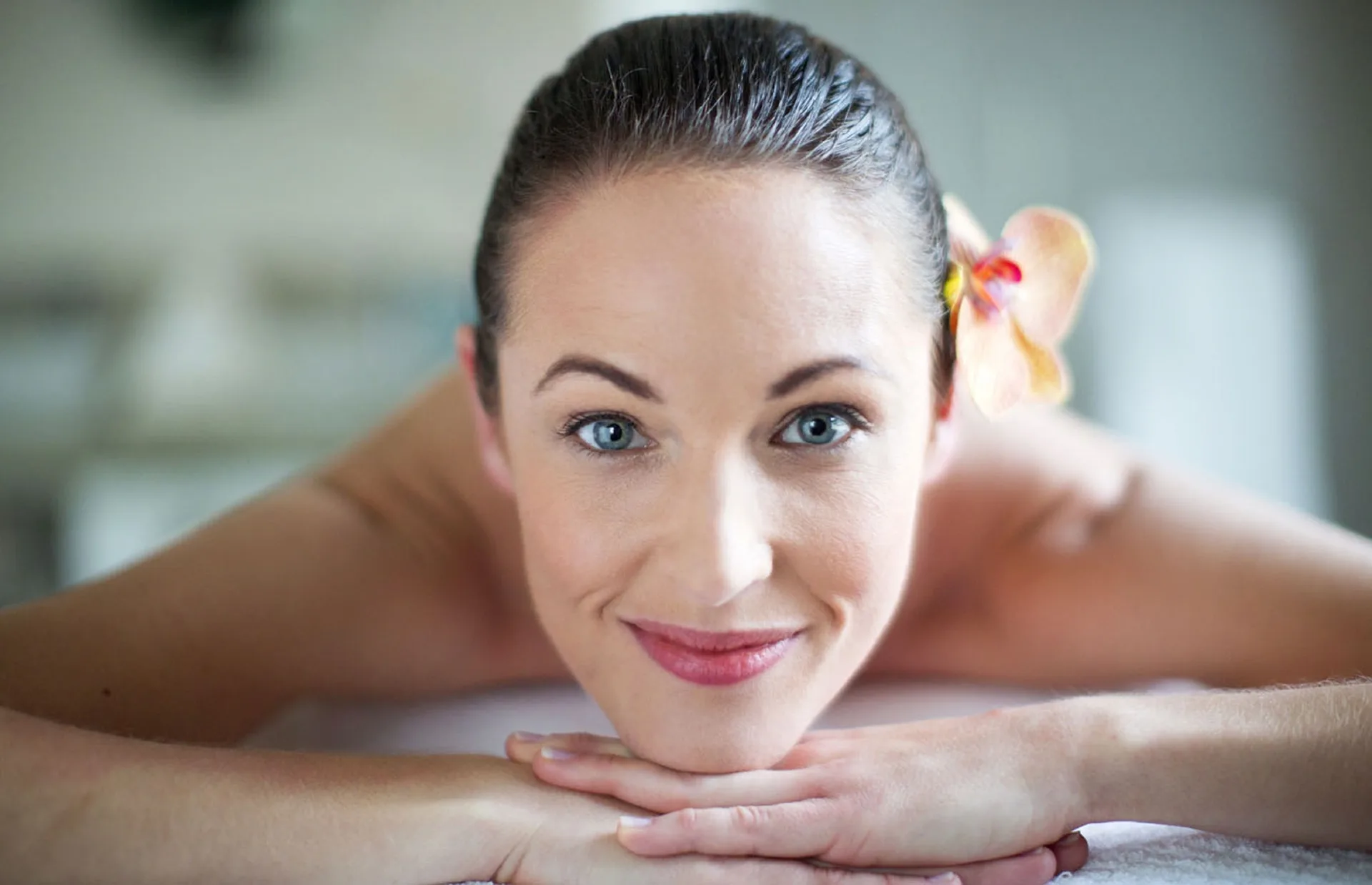 Spa guest resting face down with a flower in her hair at Royalton Negril.