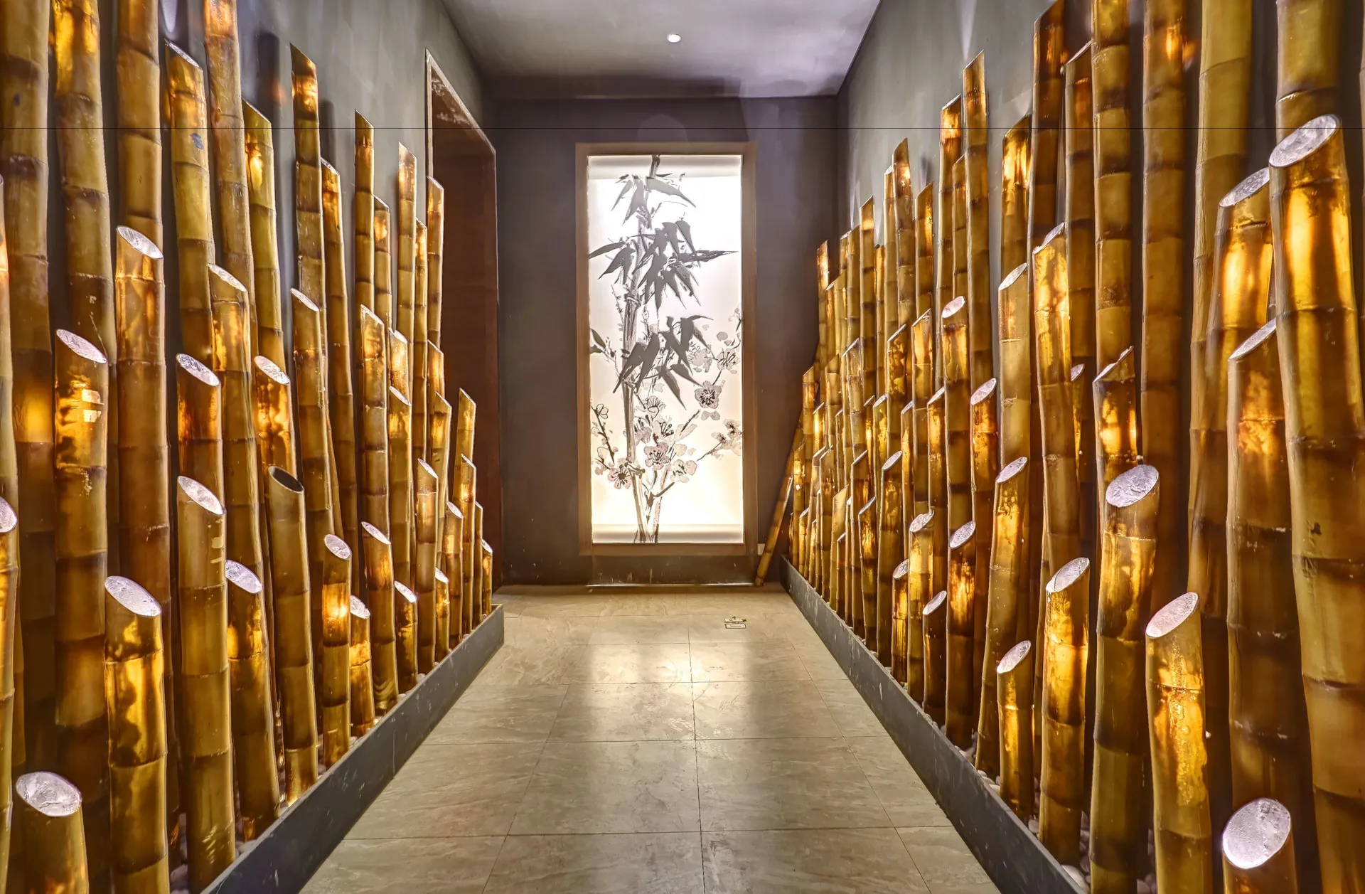 Bamboo-lined restaurant corridor with illuminated wall accents at Royalton Negril.