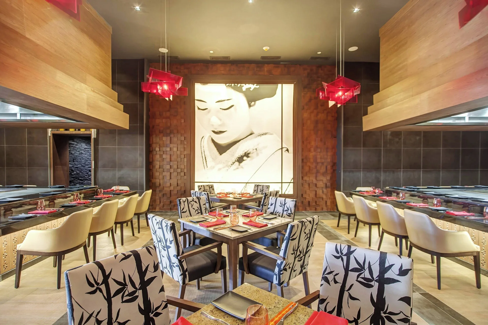 Japanese-style restaurant with sushi bars and red table accents at Royalton Negril.