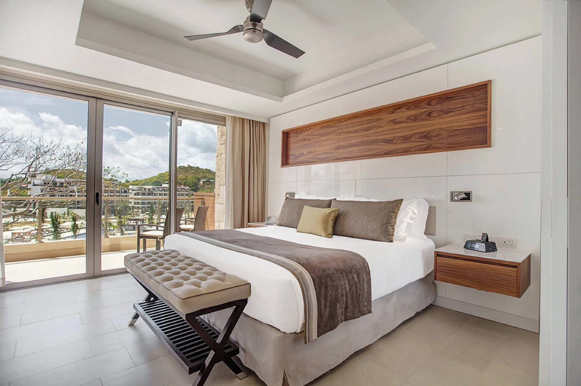 Luxury Family Suite Ocean View king bedroom with balcony and resort view at Royalton Negril.