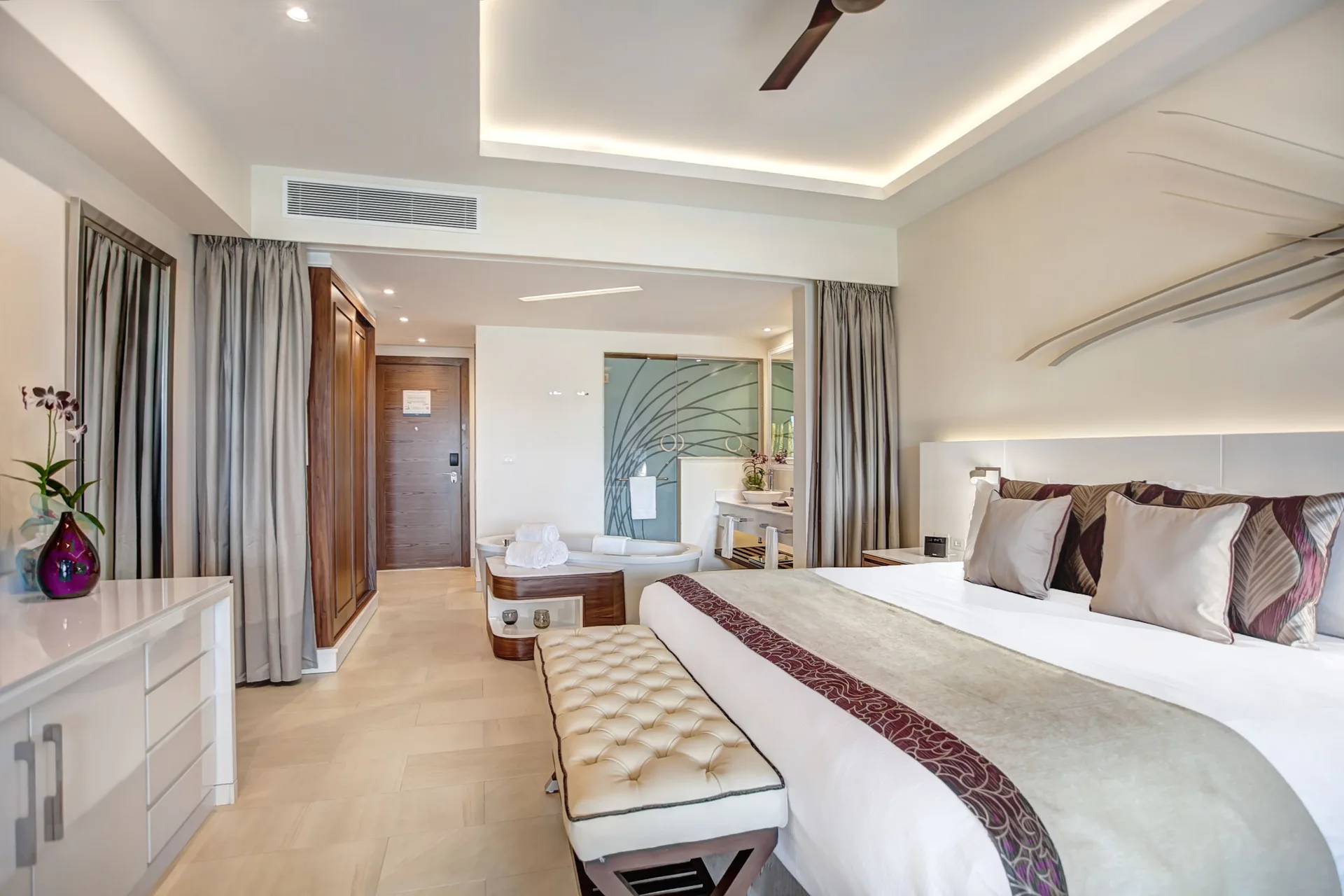 Luxury Junior Suite king bed and open bath area at Royalton Negril.