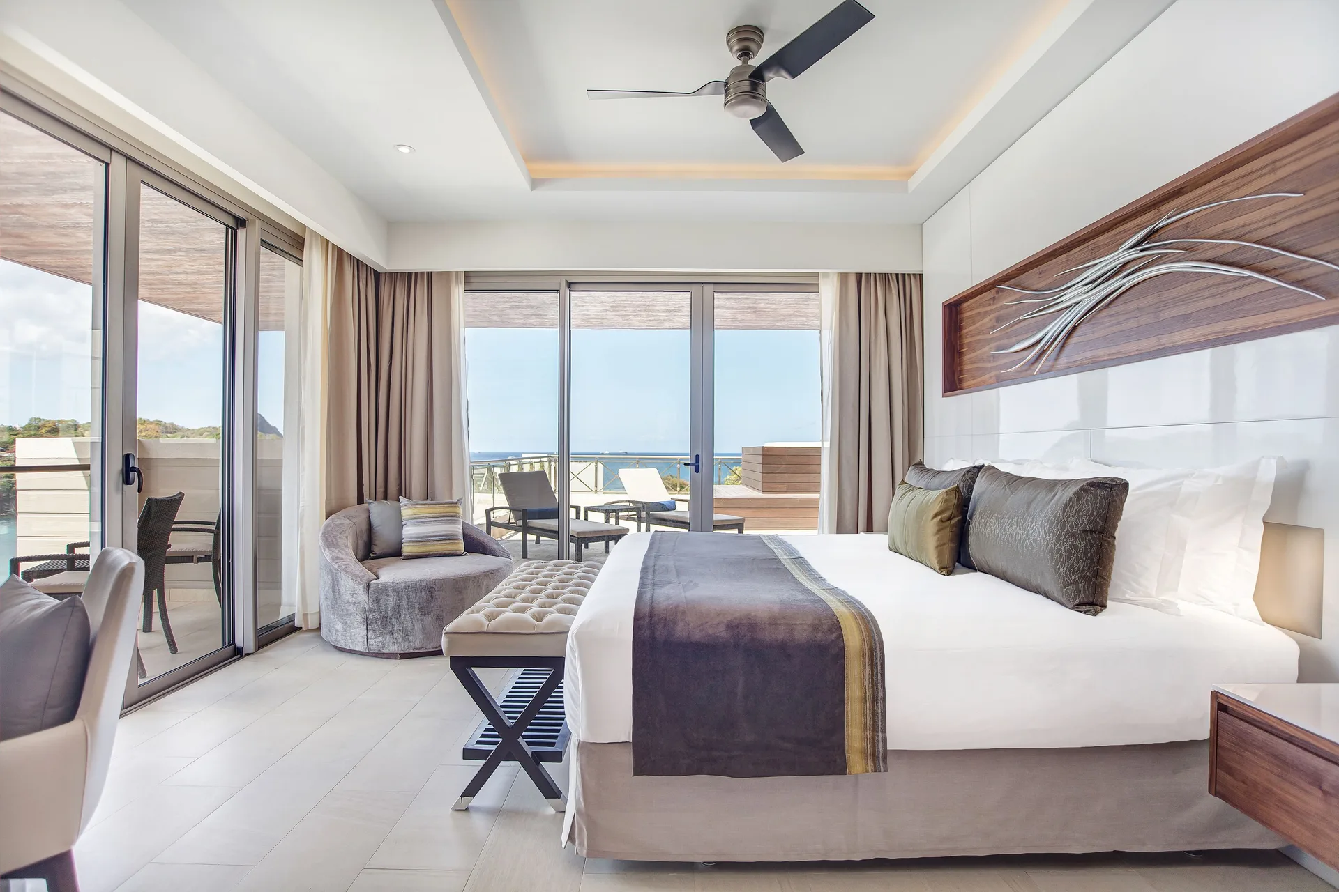 Ocean-view penthouse bedroom with king bed and terrace doors at Royalton Negril.