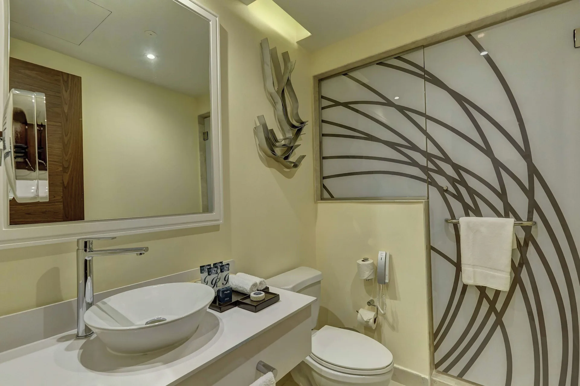 Penthouse suite powder room with vessel sink and glass shower at Royalton Negril.
