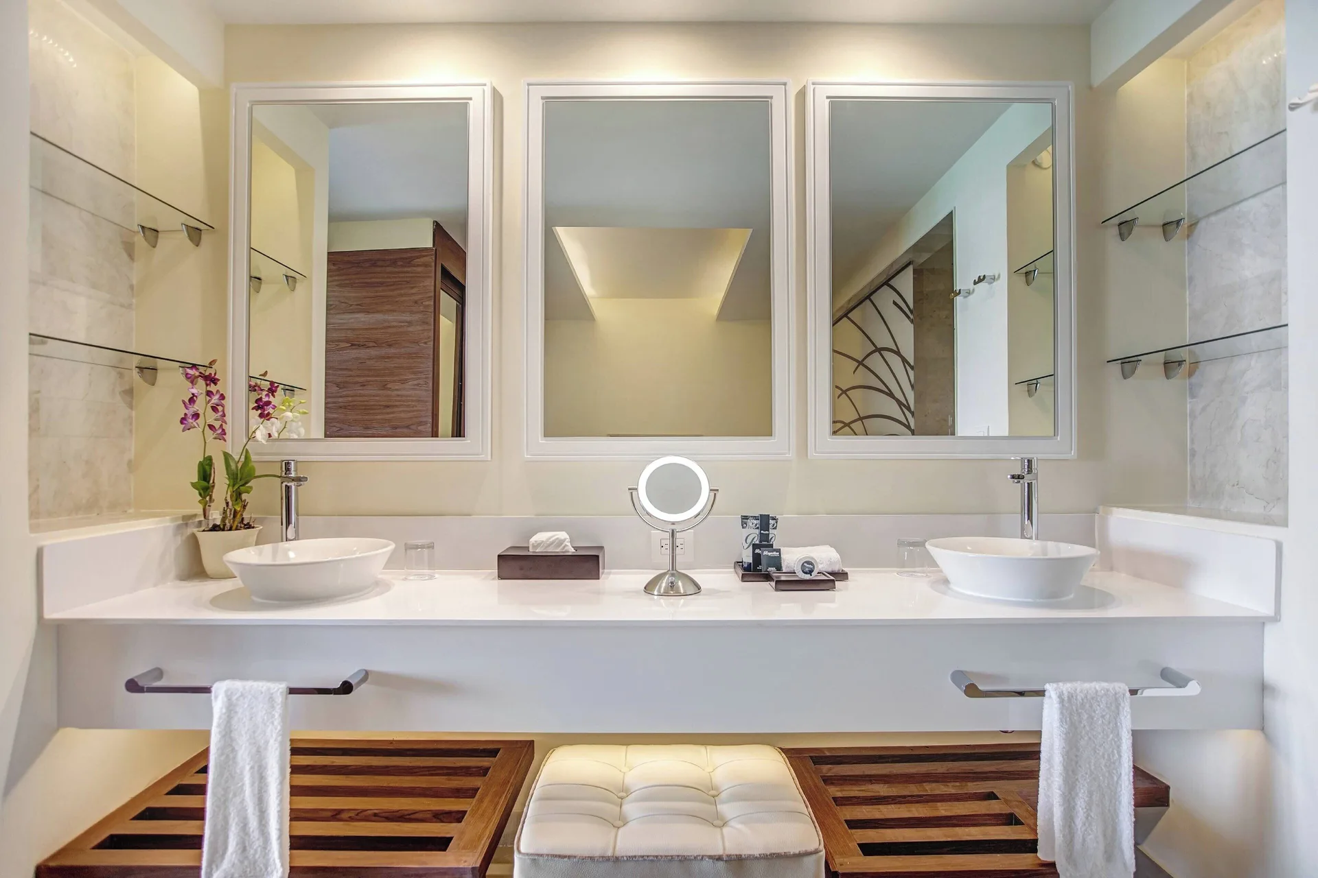 Symmetrical double vanity bathroom in a Luxury Presidential suite at Royalton Negril with bench seating.