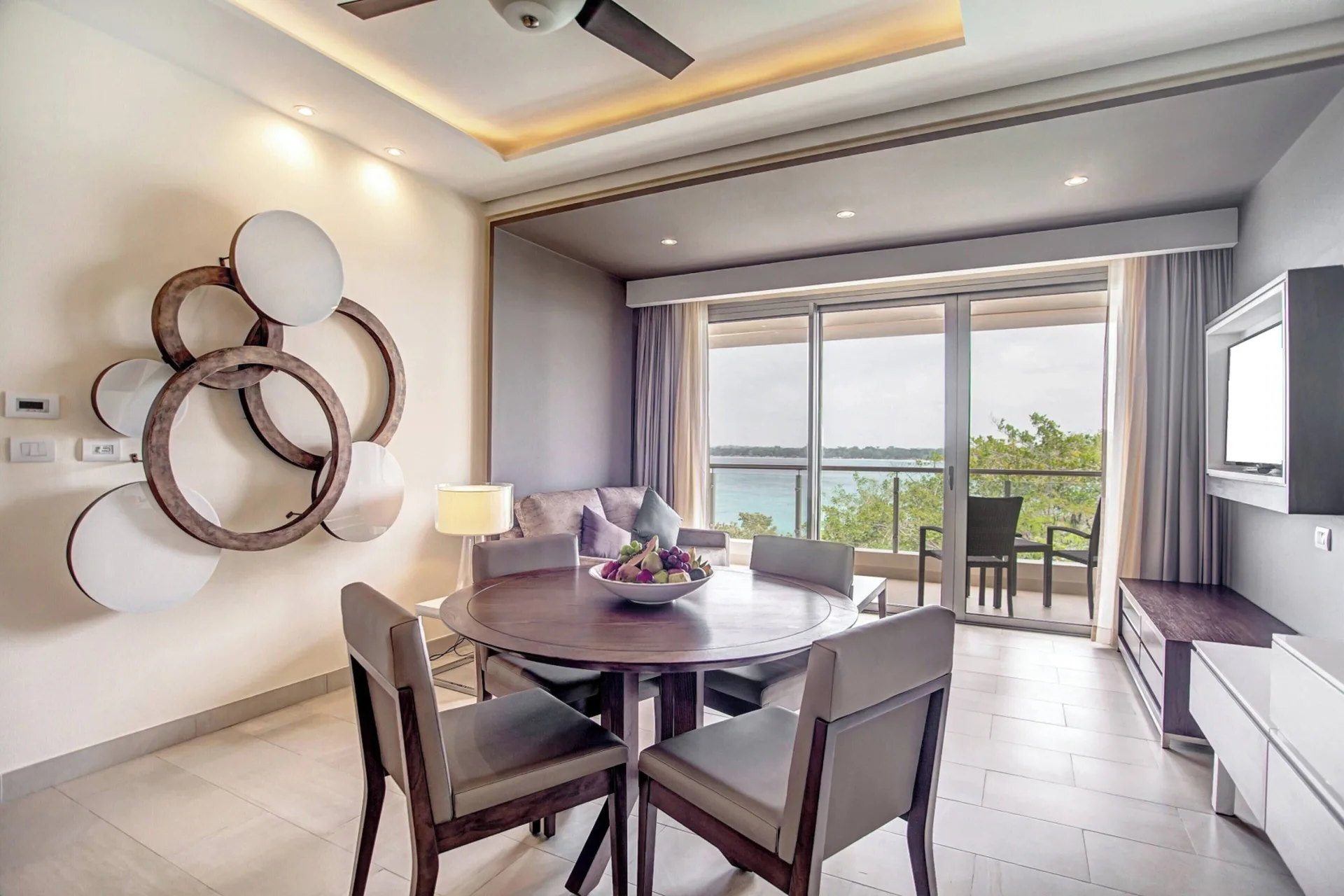 Dining table and sitting area with balcony ocean view at Royalton Negril.