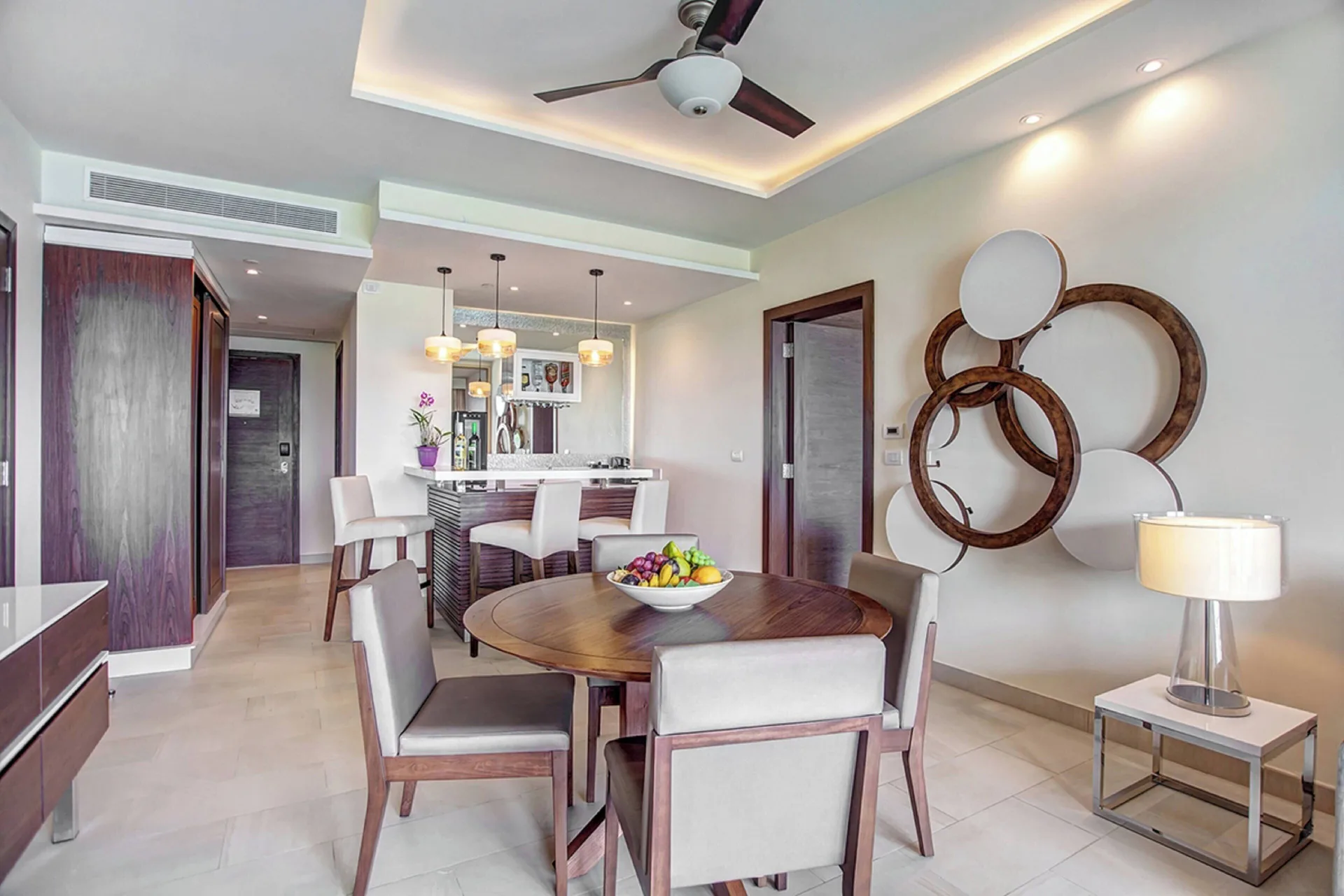 Dining table, wet bar, and wall decor in a Royalton Negril suite.