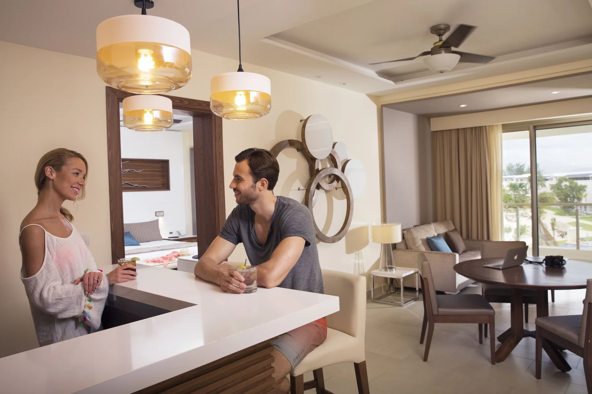 Guests at the wet bar in a Royalton Negril suite living area.