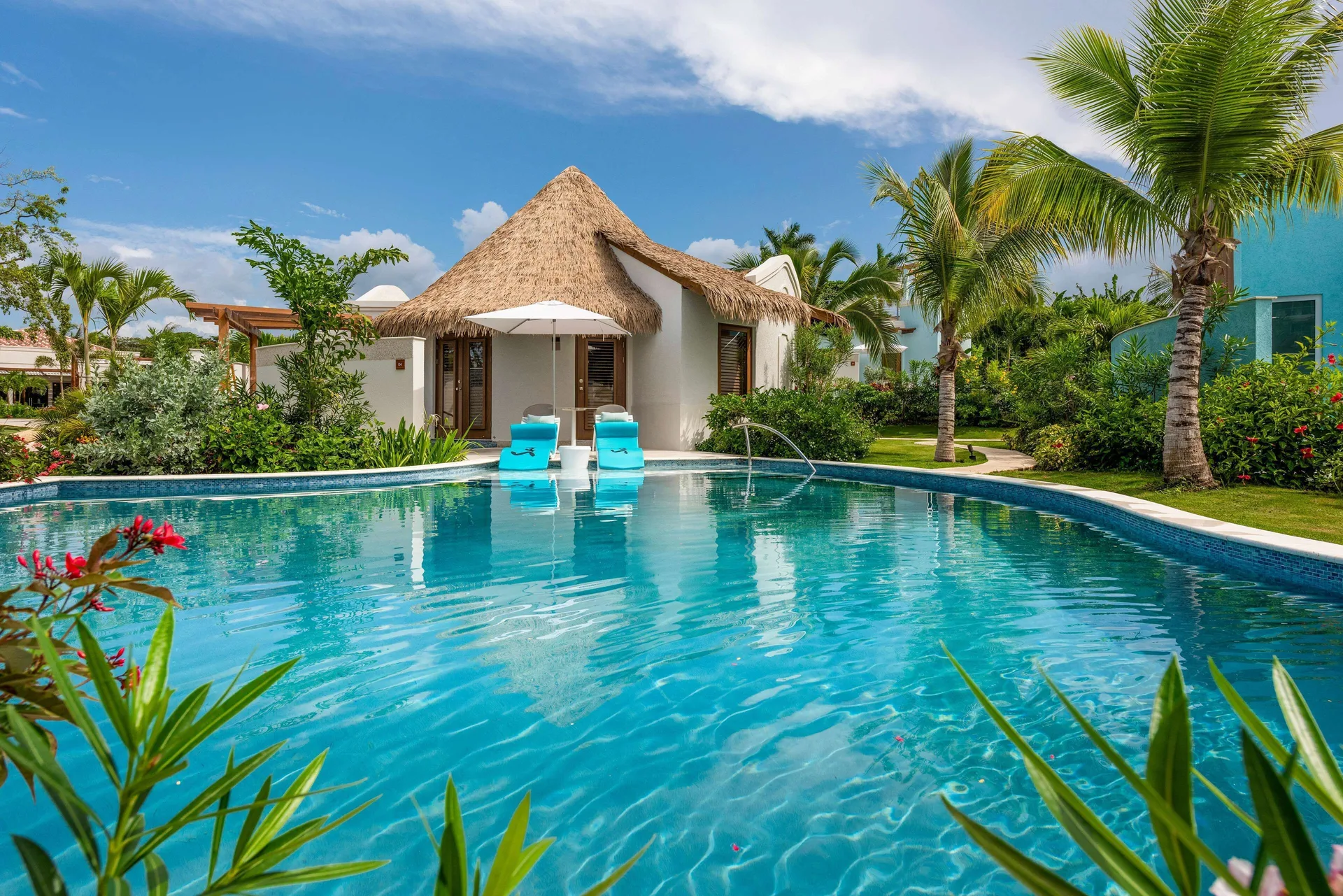 Thatched villa beside a quiet pool at Sandals Dunns River.