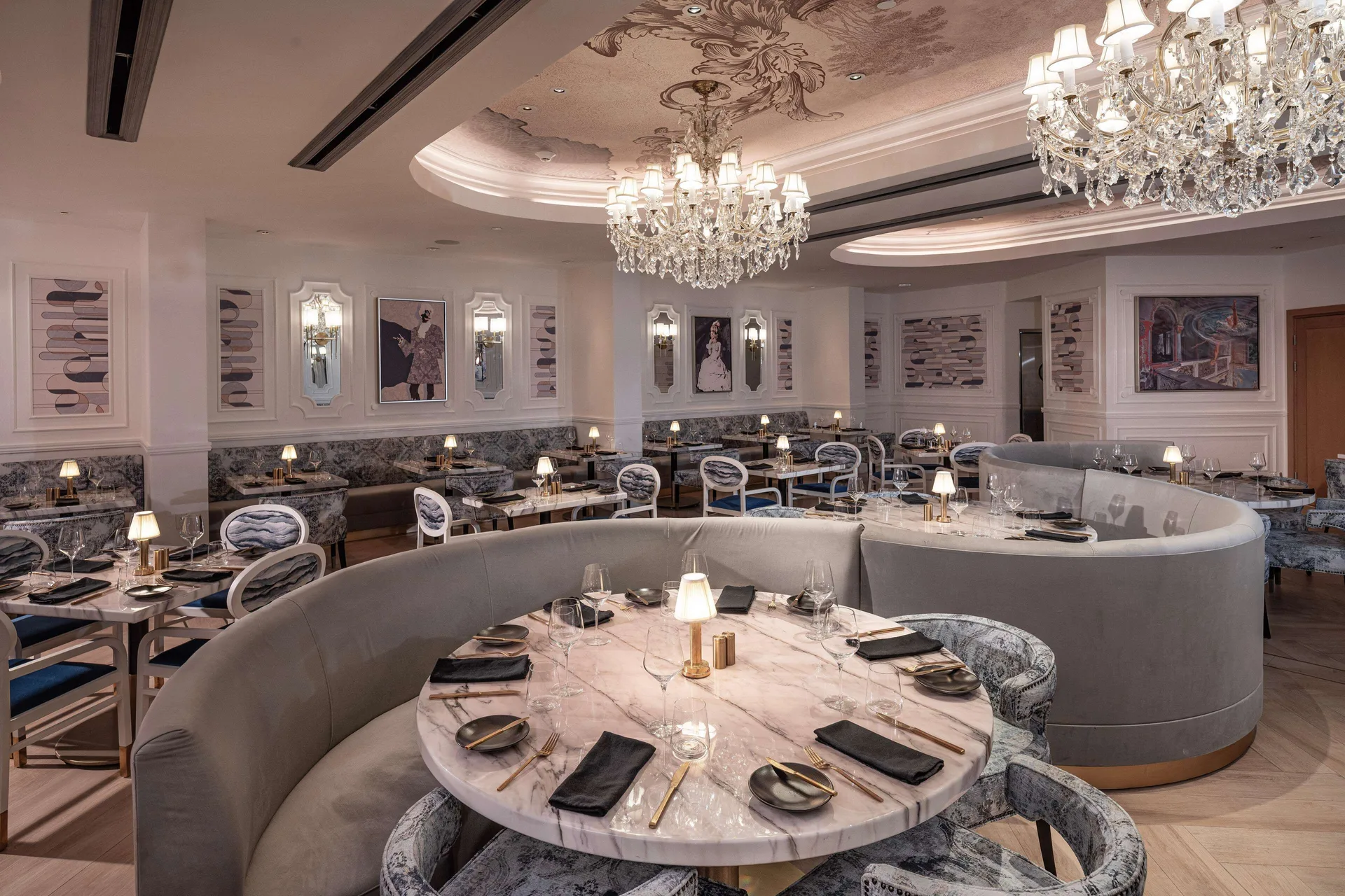 Elegant chandelier dining room with marble tables at Sandals Dunns River.