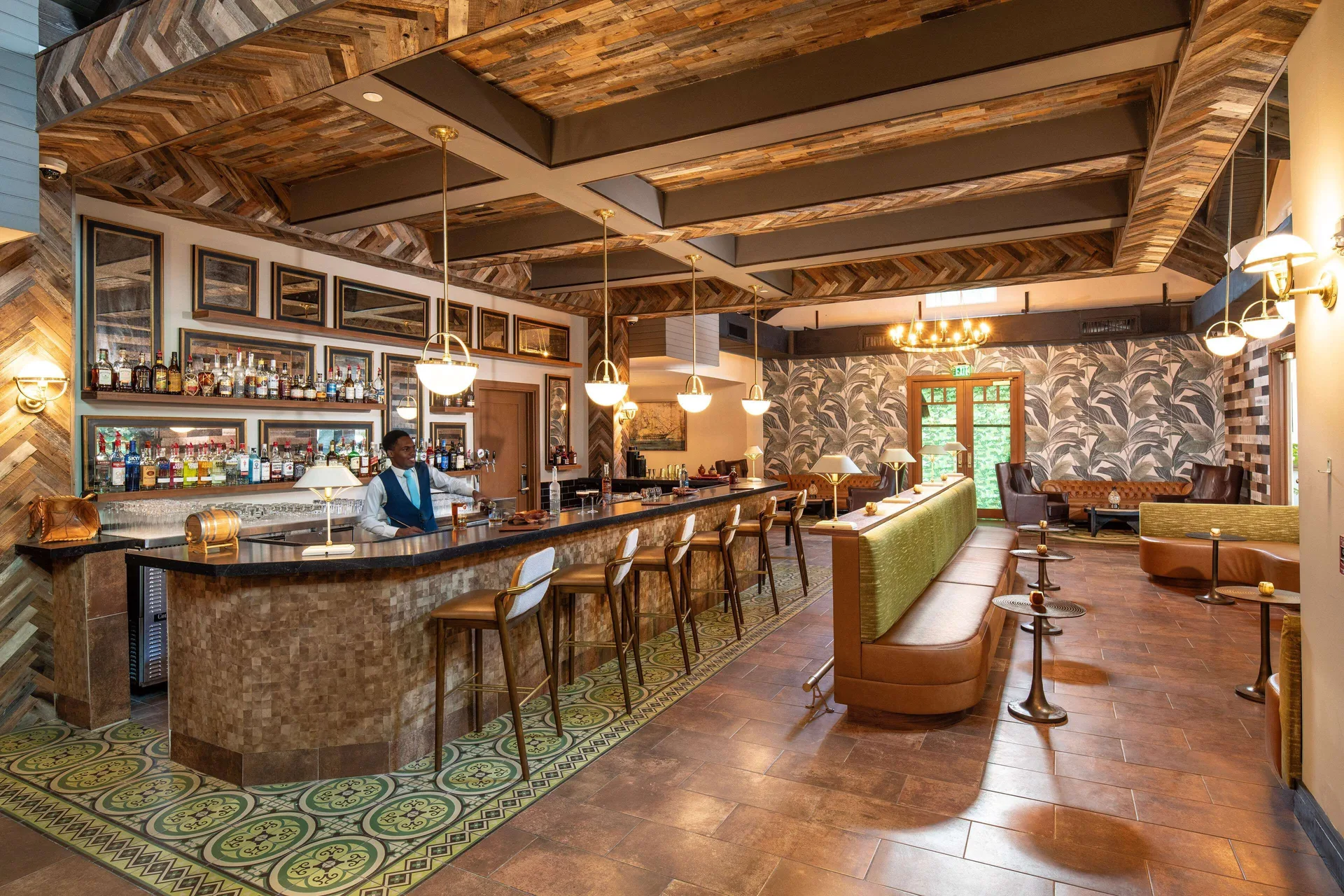 Rum bar with wood ceiling, bottle shelves and lounge seating at Sandals Dunns River.