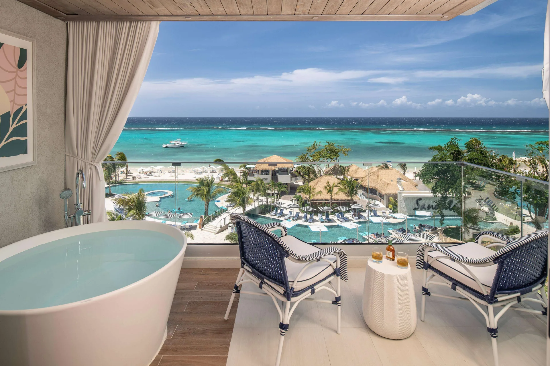 Beachfront balcony with soaking tub and ocean view at Sandals Dunns River.