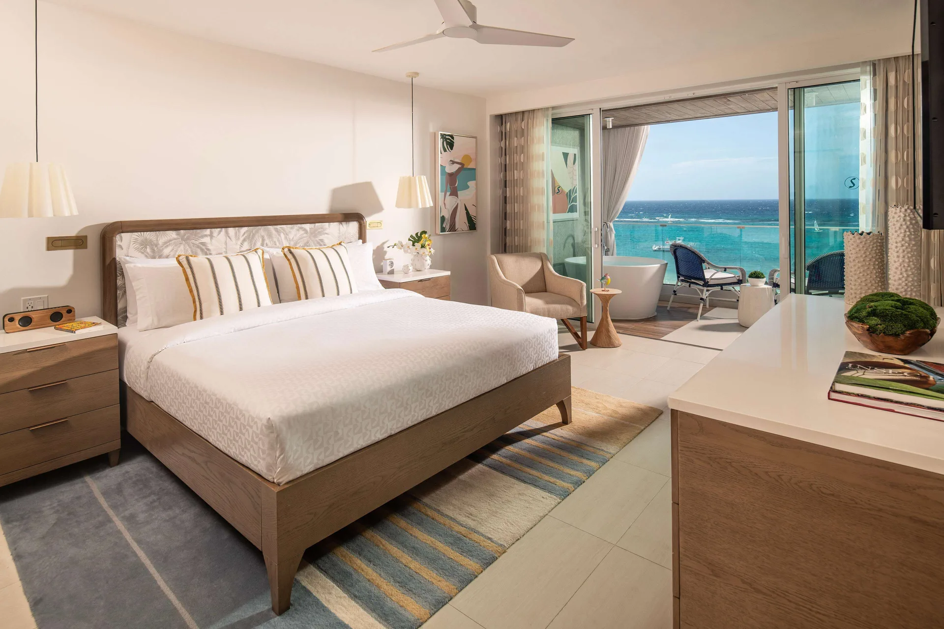 Beachfront club room with king bed and ocean-view balcony at Sandals Dunns River.