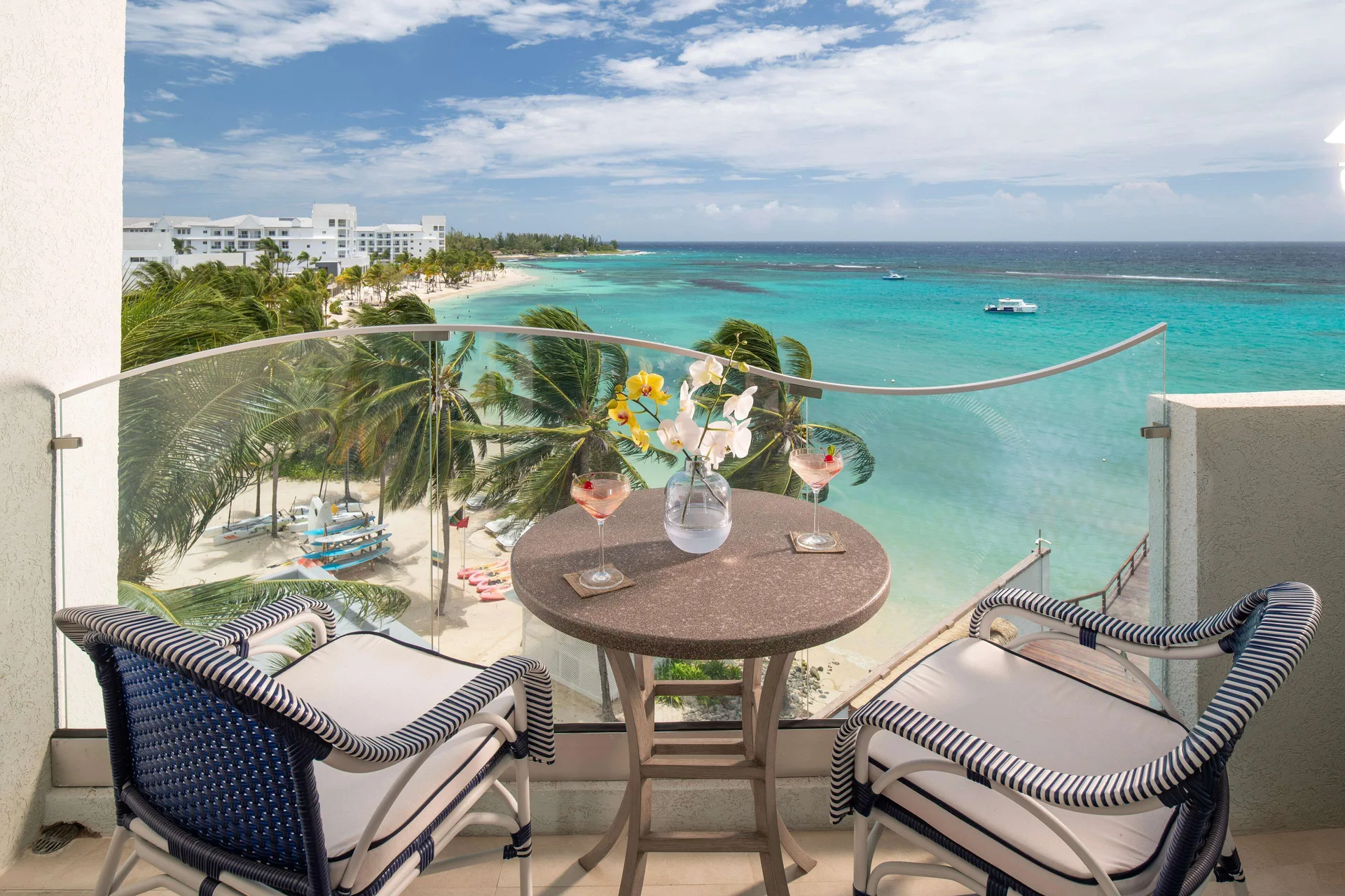 Mammee Bay Club Level balcony with ocean view and two chairs at Sandals Dunns River.