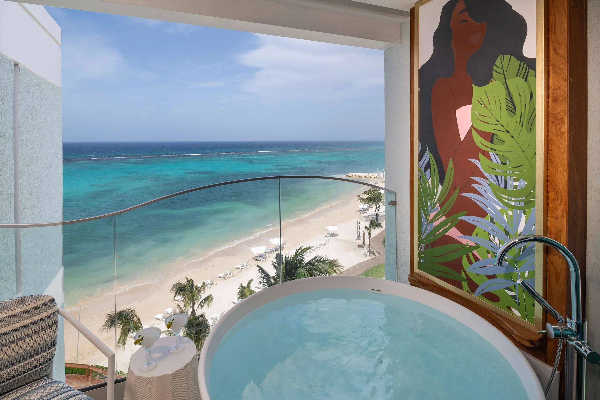 Ocean view balcony with soaking tub and beach view at Sandals Dunns River.