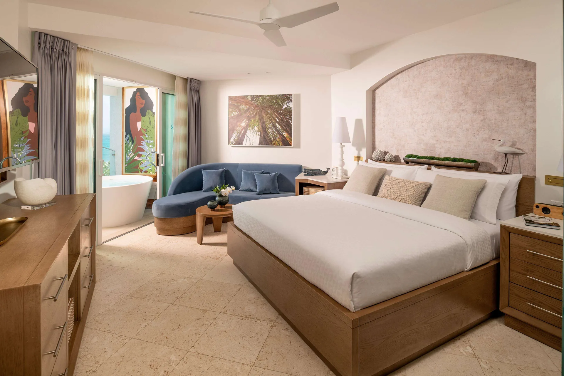 Club Level ocean view room with king bed, sofa, and balcony tub at Sandals Dunns River.