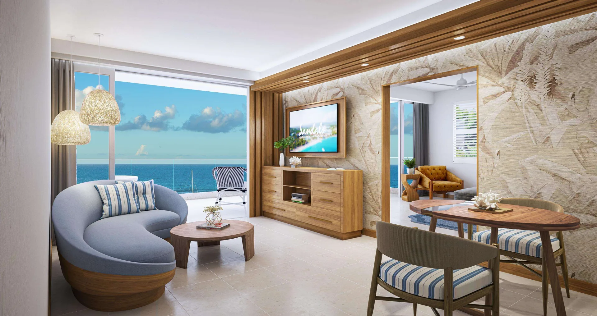 Living area with ocean-facing balcony in a beachfront suite at Sandals Dunns River.