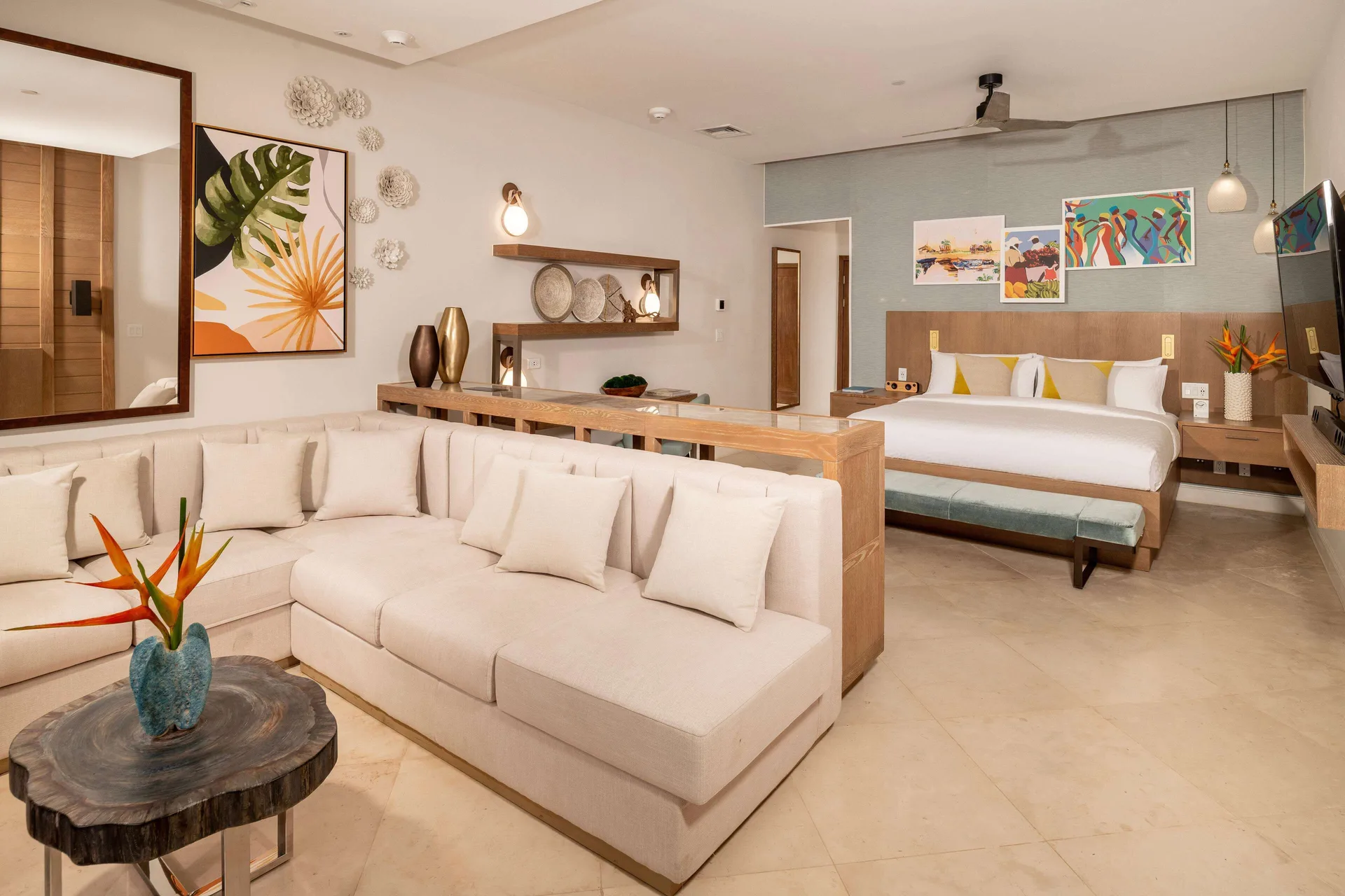 One-bedroom suite living area and king bed at Sandals Dunns River.