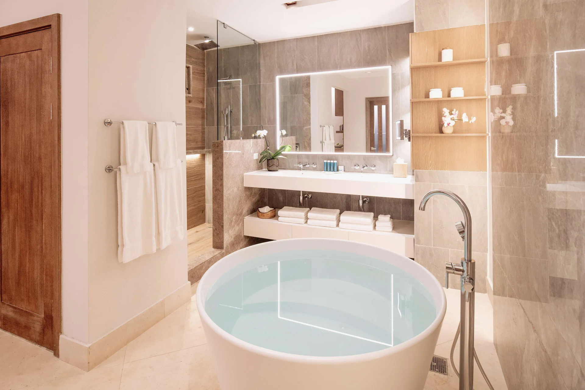 Modern suite bathroom with round tub and double vanity at Sandals Dunns River.
