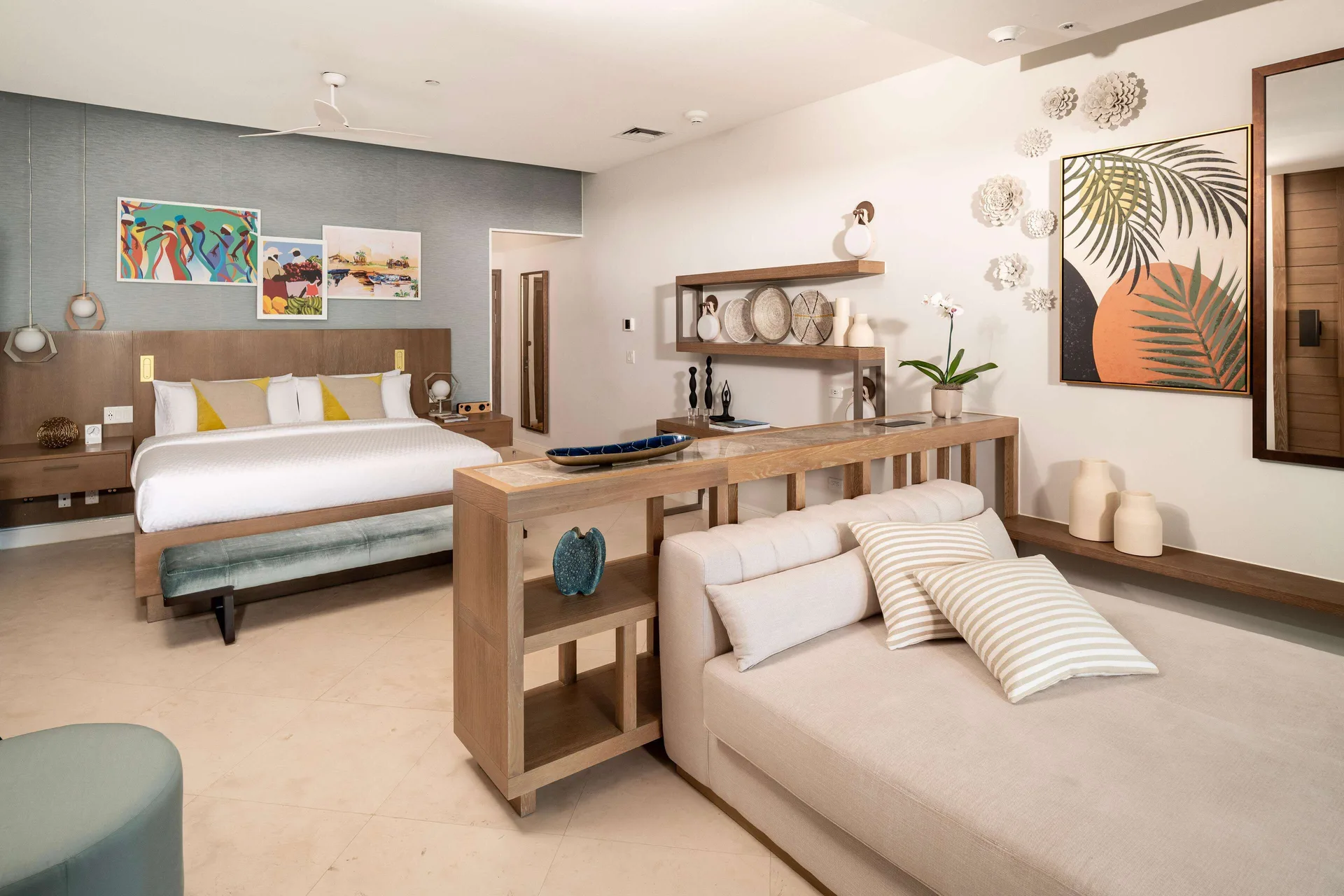 Spacious suite bedroom and lounge area at Sandals Dunns River with king bed and daybed.