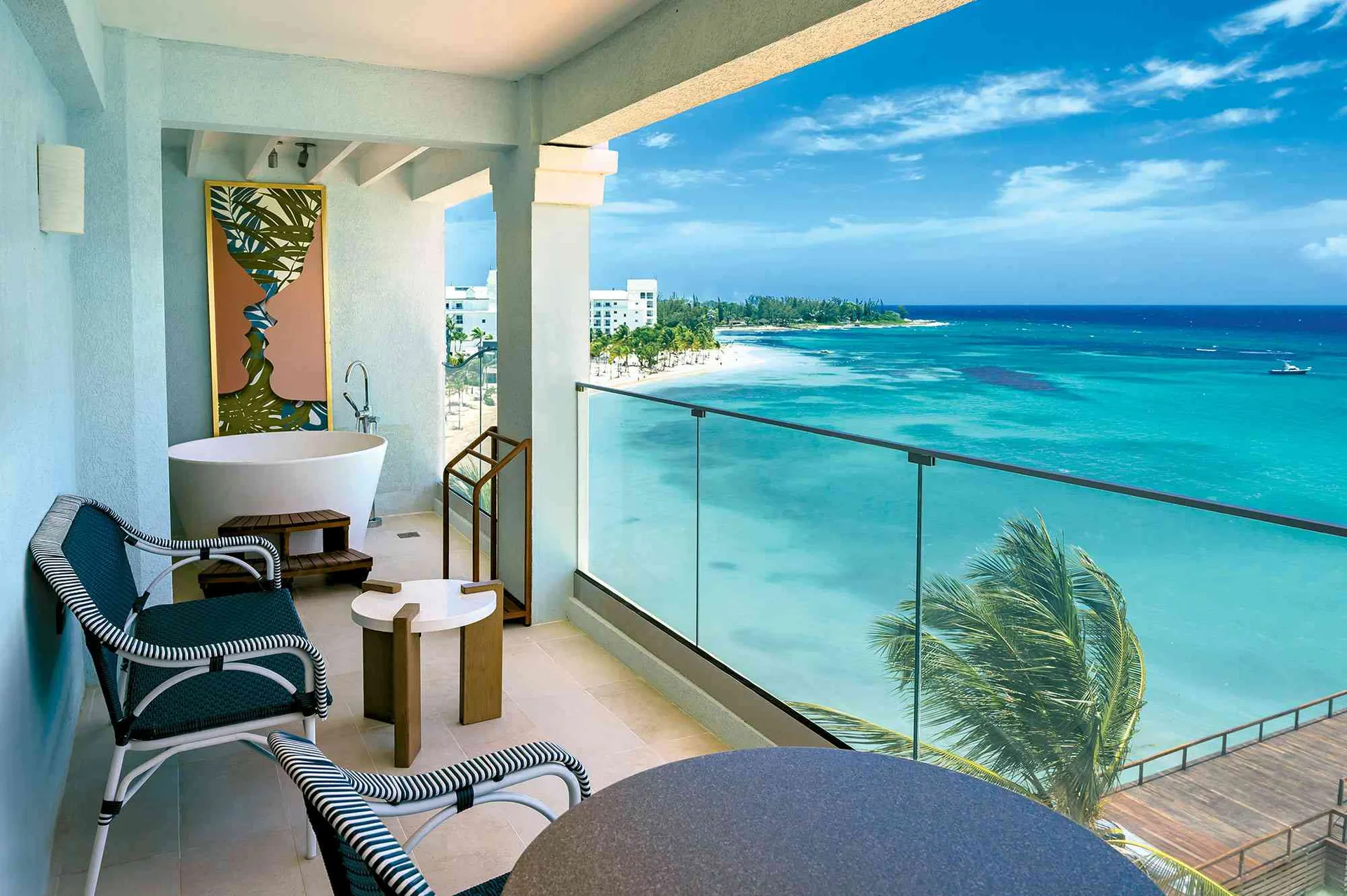 Travertine Luxury Room balcony with soaking tub and ocean view at Sandals Dunns River.