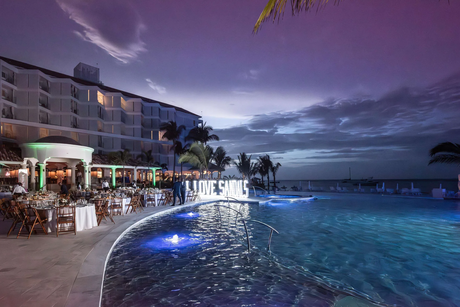 Evening poolside event beside the ocean at Sandals Dunns River.