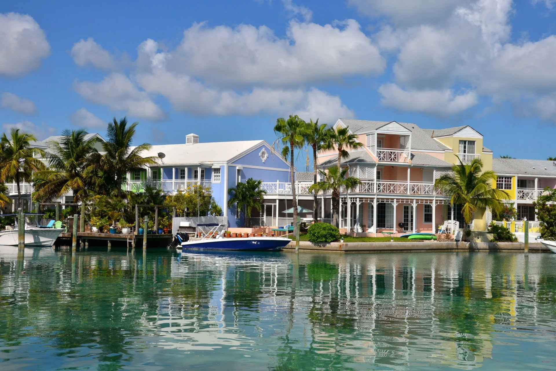 Colorful canal-front resort buildings and boats at Sandyport Beach Resort.