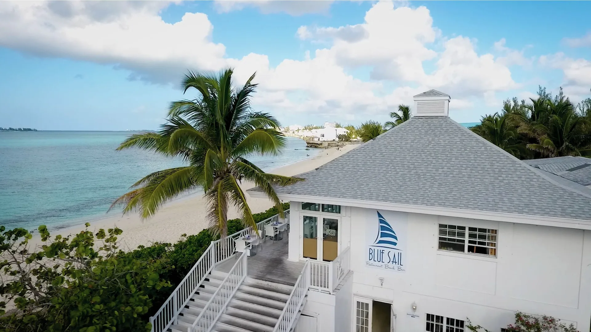 Blue Sail building stands beside the beach at Sandyport Beach Resort.