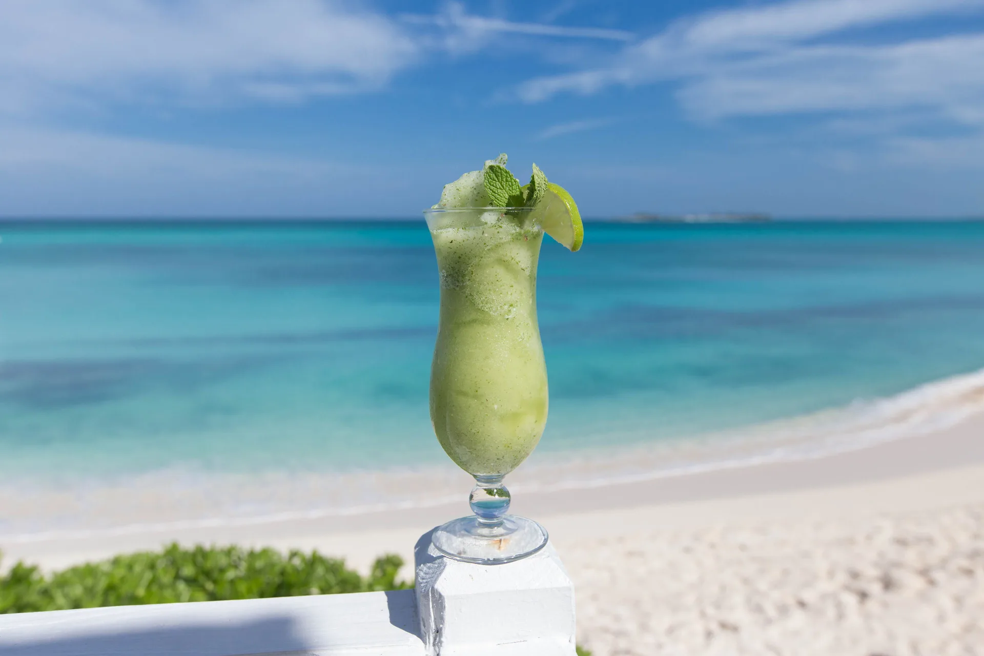 Green frozen drink with lime and mint by the beach at Sandyport Beach Resort.