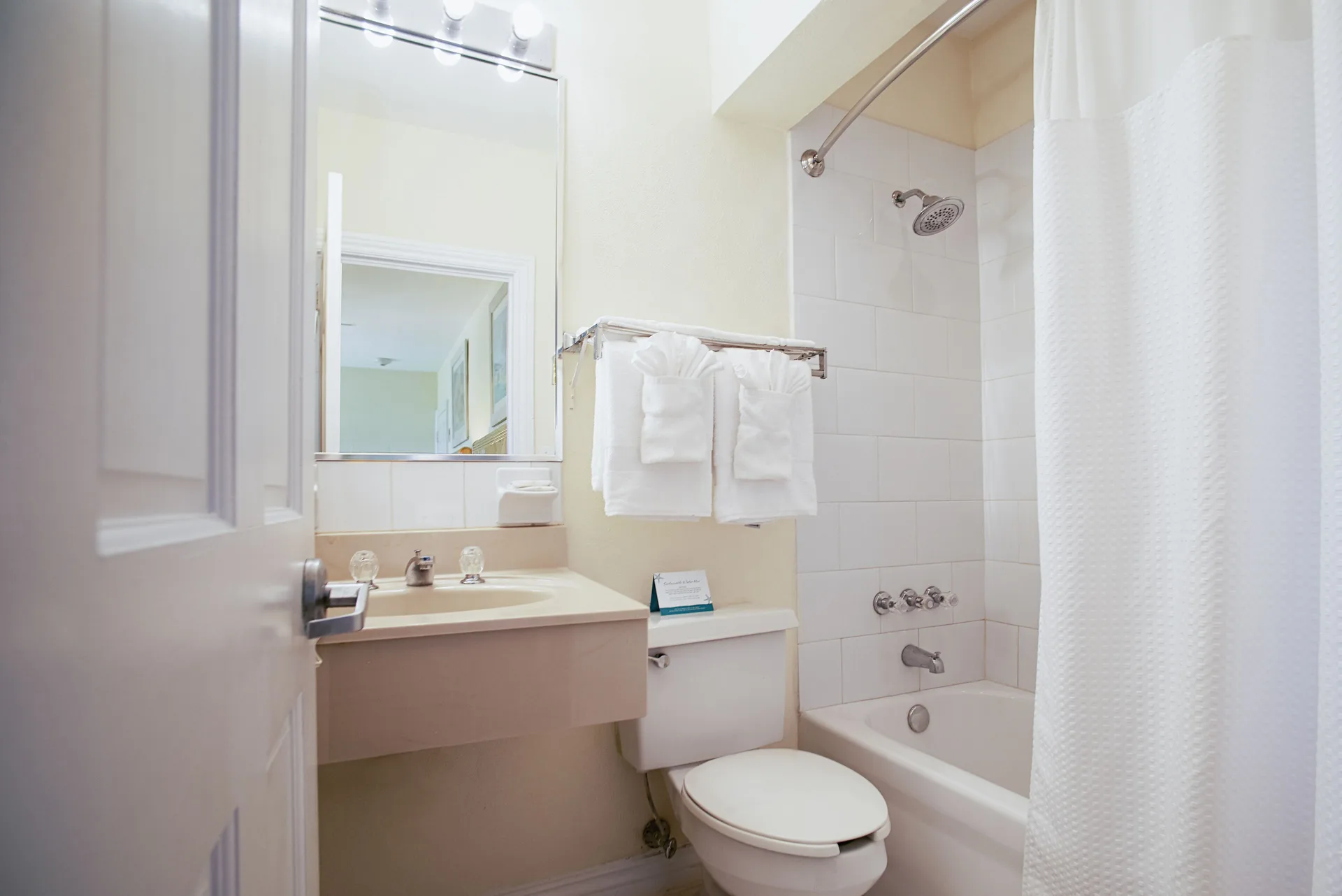Standard Studio bathroom with tub shower at Sandyport Beach Resort.