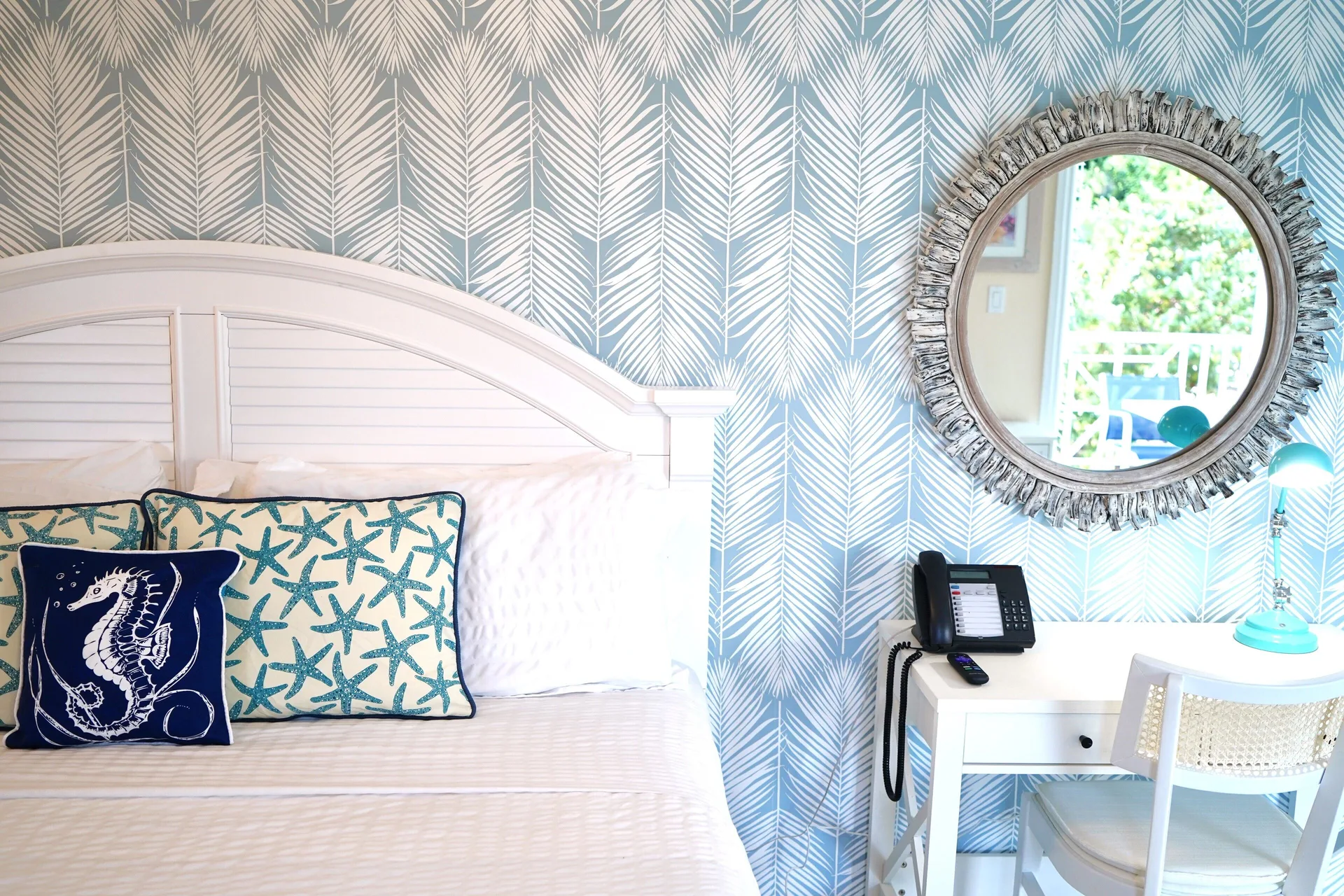 Standard Studio king bed and writing desk at Sandyport Beach Resort.