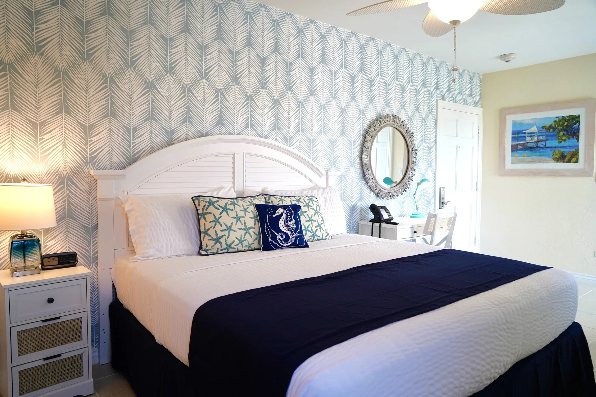 Standard Studio king bed with coastal decor at Sandyport Beach Resort.