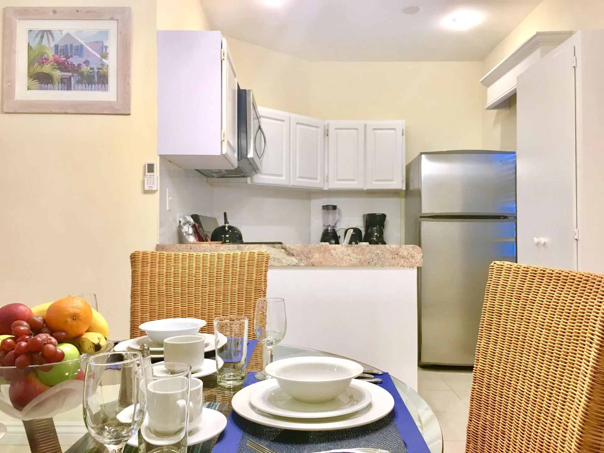 Dining table set in front of the suite kitchen at Sandyport Beach Resort.