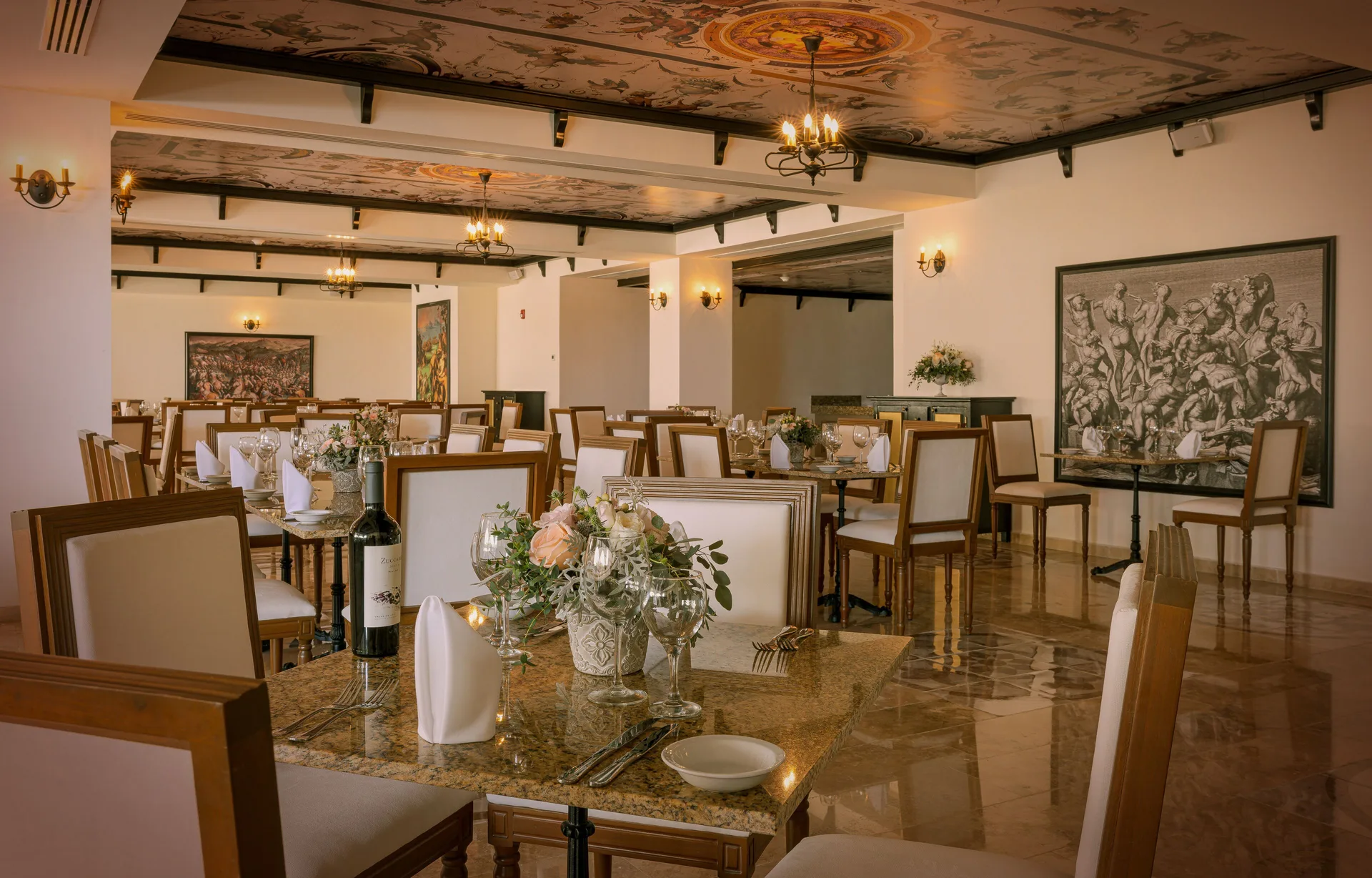 Formal dining room with chandeliers and set tables at Sensira Resort & Spa Riviera Maya.