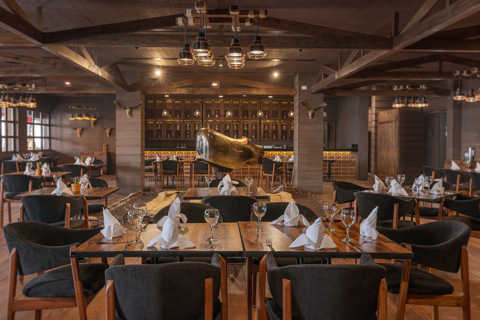 Steakhouse-style dining room with a bull sculpture at Sensira Resort & Spa Riviera Maya.