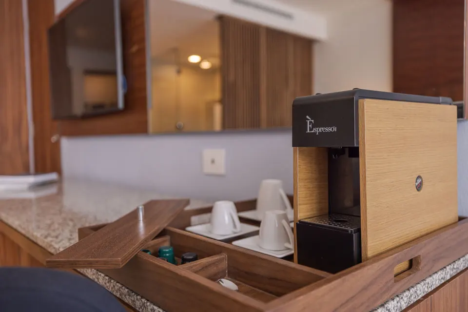 Agatha room coffee station with cups and machine at Sensira Resort & Spa Riviera Maya.